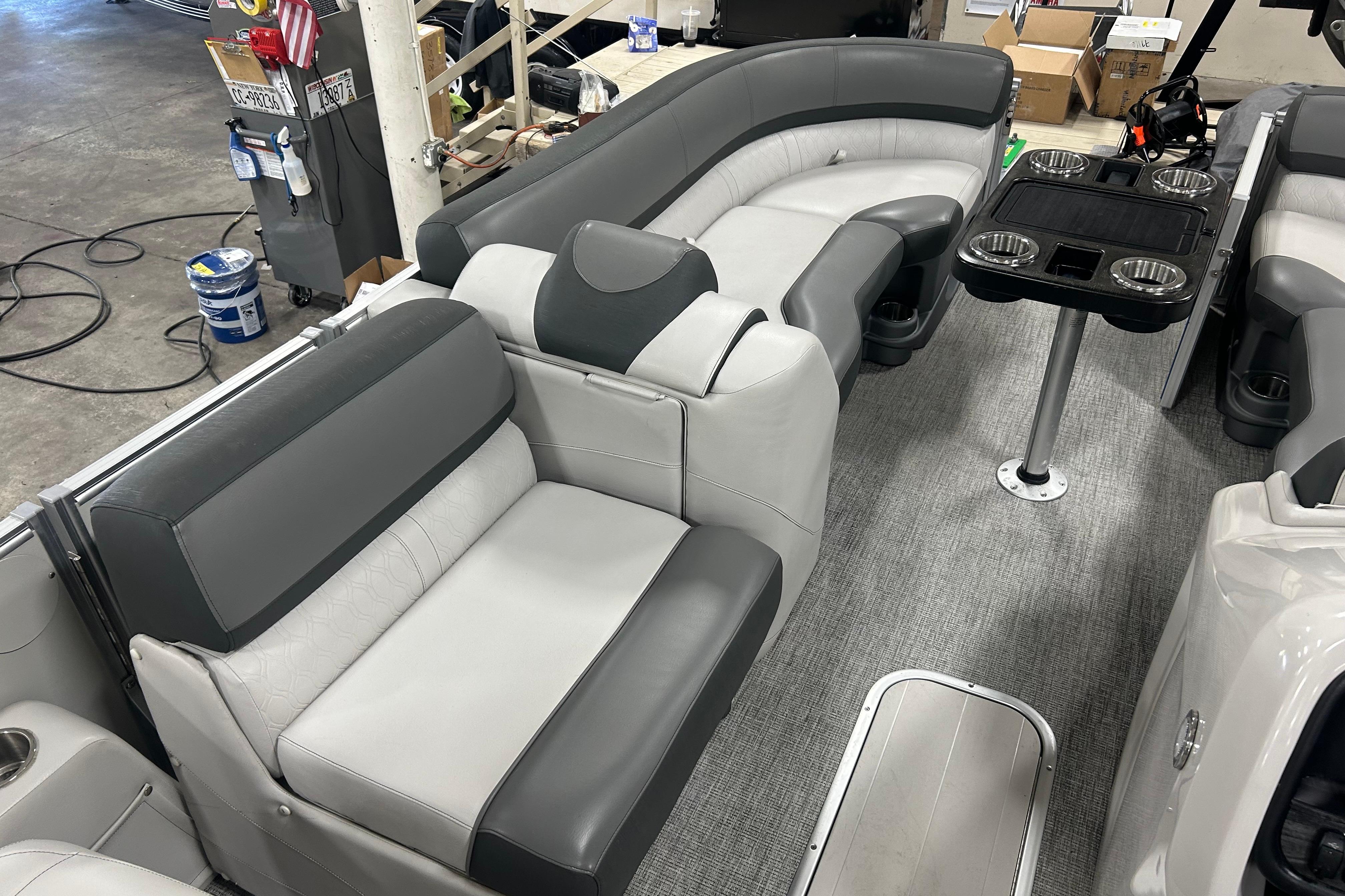 2022 Tahoe Pontoon Cascade Quad Lounger interior with gray seating and cup holders.