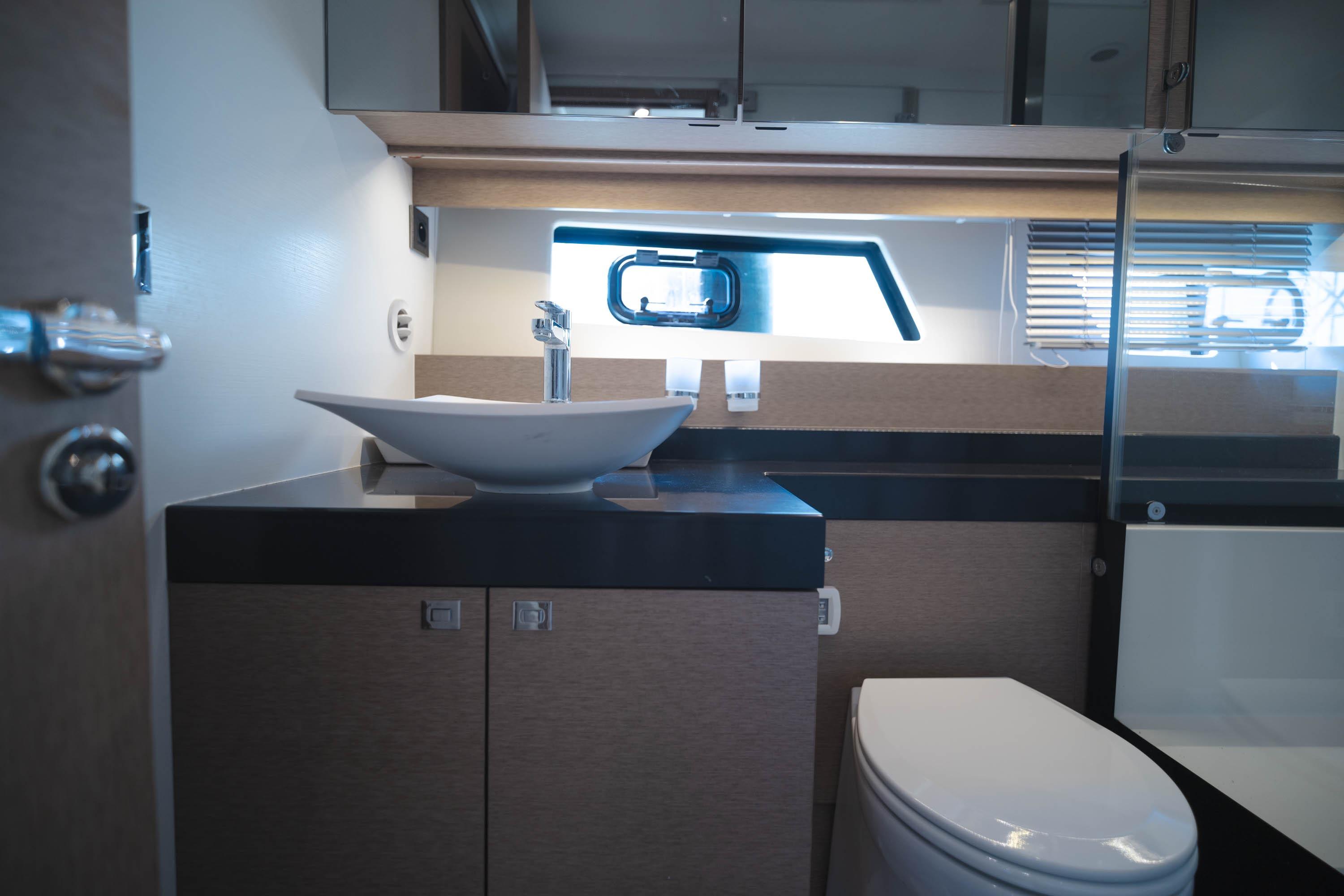 Luxurious bathroom interior of 2017 Prestige 560 yacht with modern fixtures.