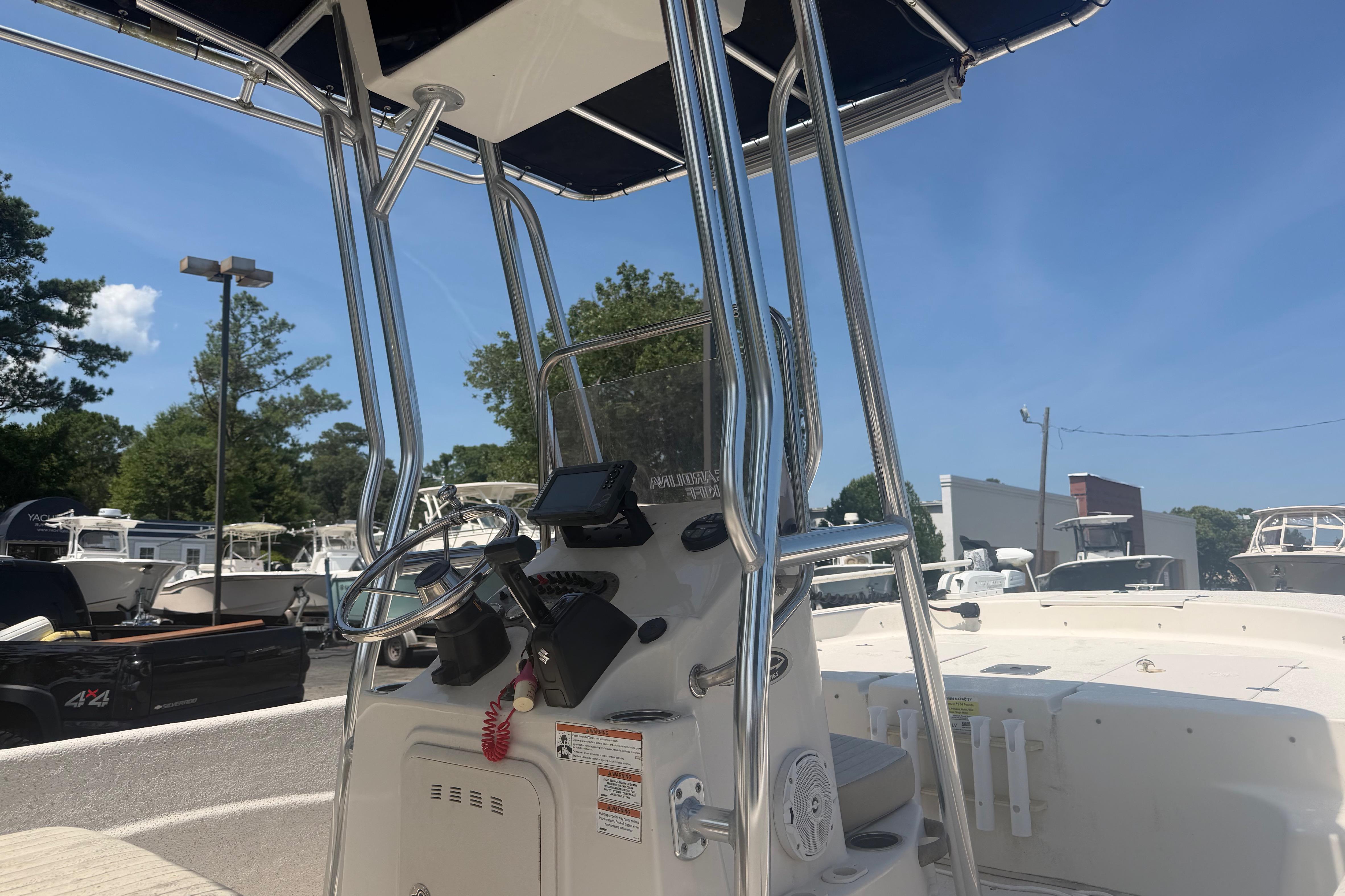 2019 Carolina Skiff 218 DLV boat console with steering wheel and navigation equipment.