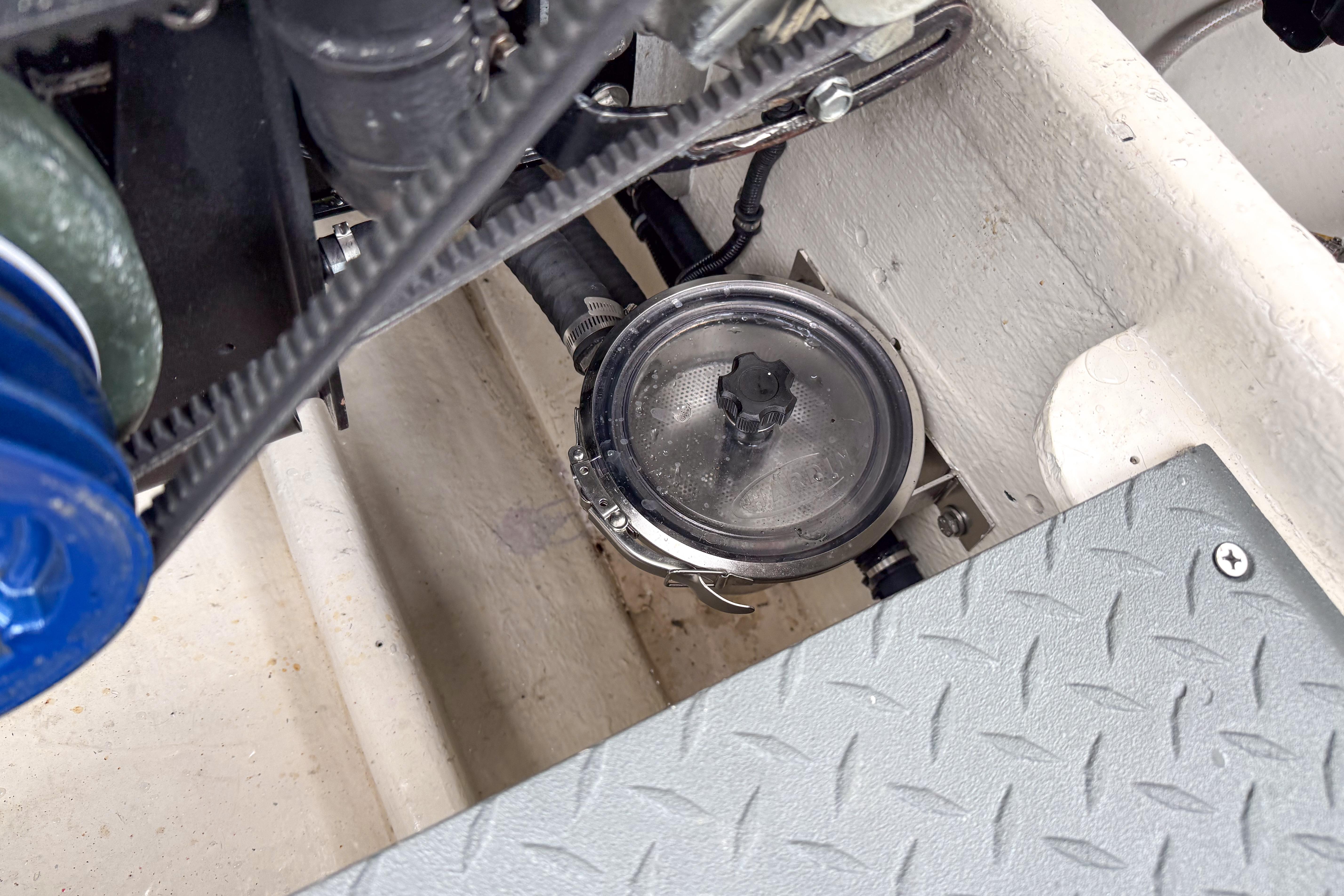 Engine compartment of a 2002 Active Thunder 37 boat, showing mechanical components and a filter.