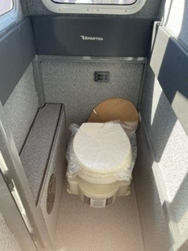 Compact bathroom in 2025 Spartan 2600 Olympia, featuring a modern toilet design.