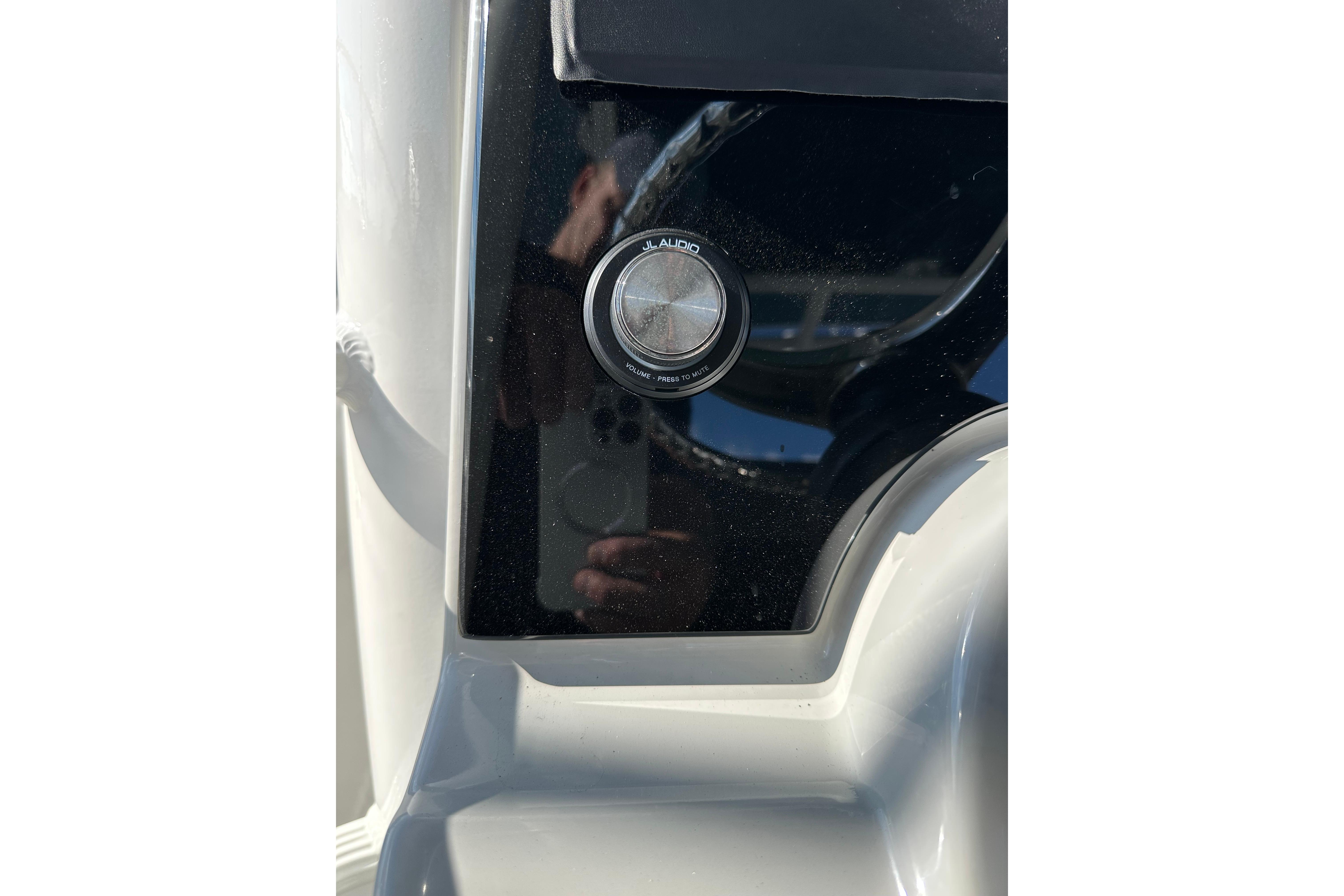 Close-up of 2023 Boston Whaler 330 Outrage audio control knob.