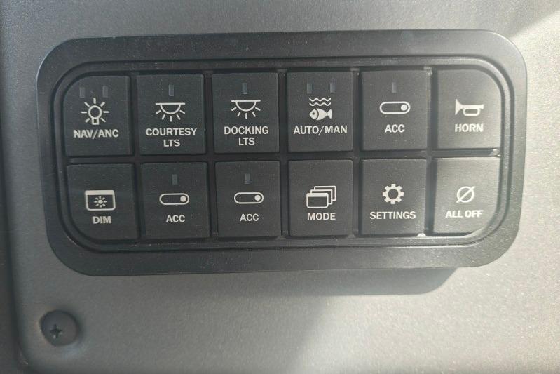 Control panel of 2026 Sun Tracker Fishin' Barge 20 DLX with various function buttons.
