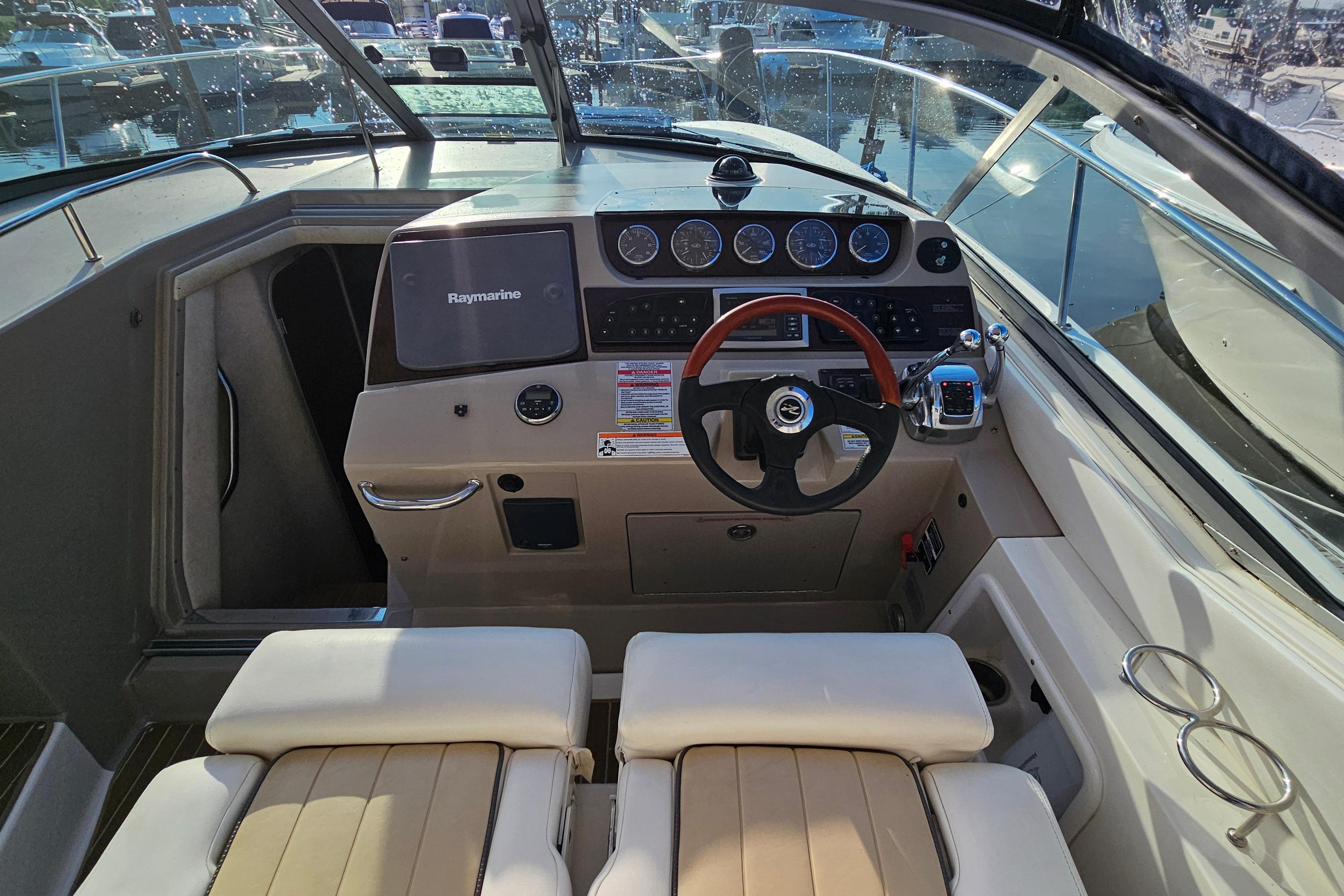 Cockpit of 2008 Sea Ray Sundancer 350 with steering wheel and navigation controls.