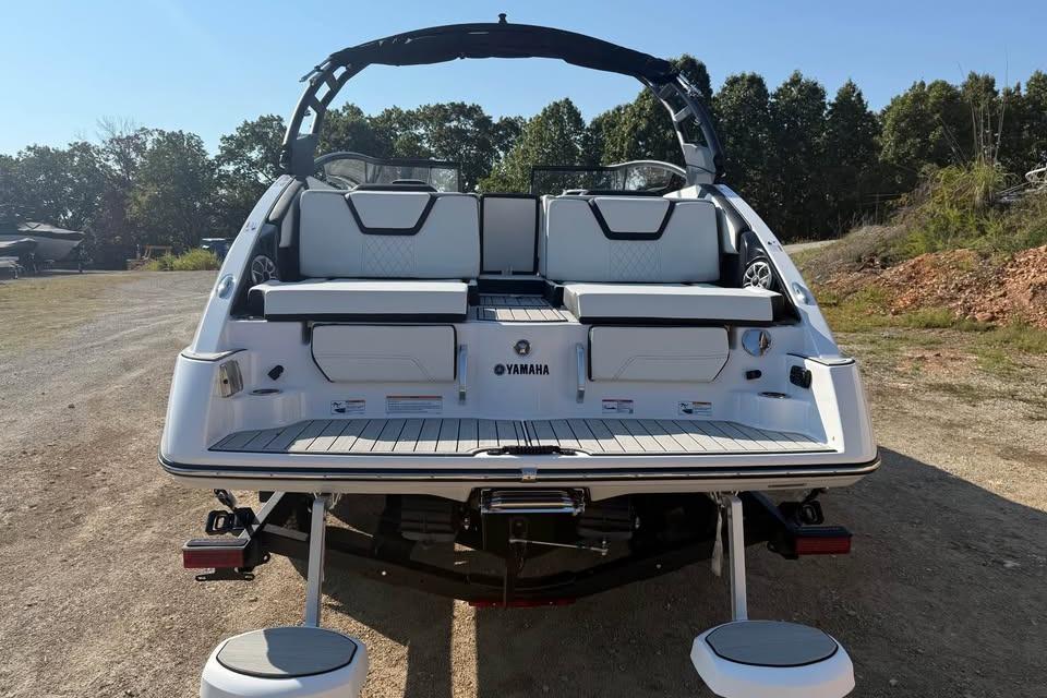 2026 Yamaha Boats 252S, rear view, on land, showcasing seating and swim platform.