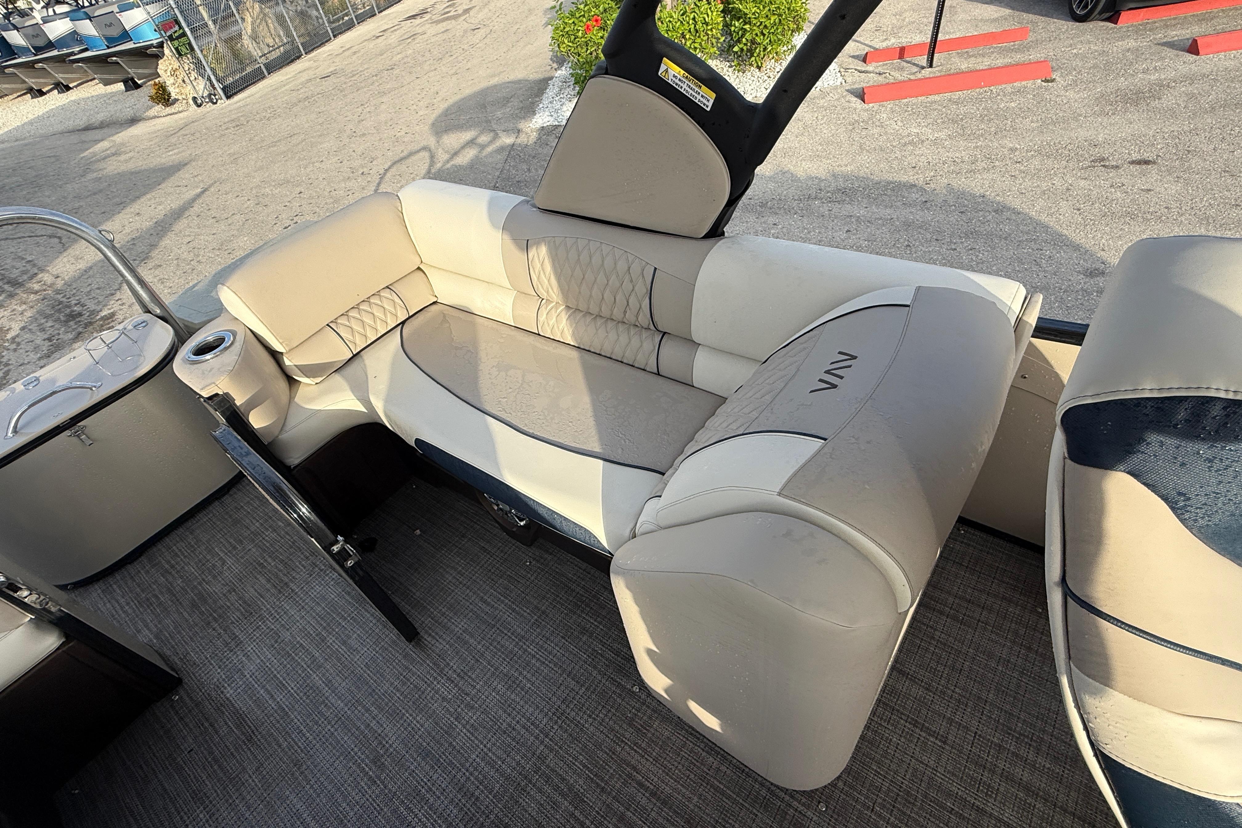 2026 Avalon 2385 Catalina Quad Lounger interior with beige seating and cup holder.
