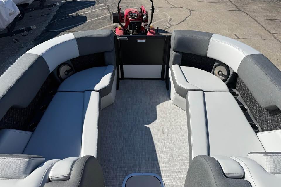 2026 Alera M 25Q boat interior with gray seating and steering console.