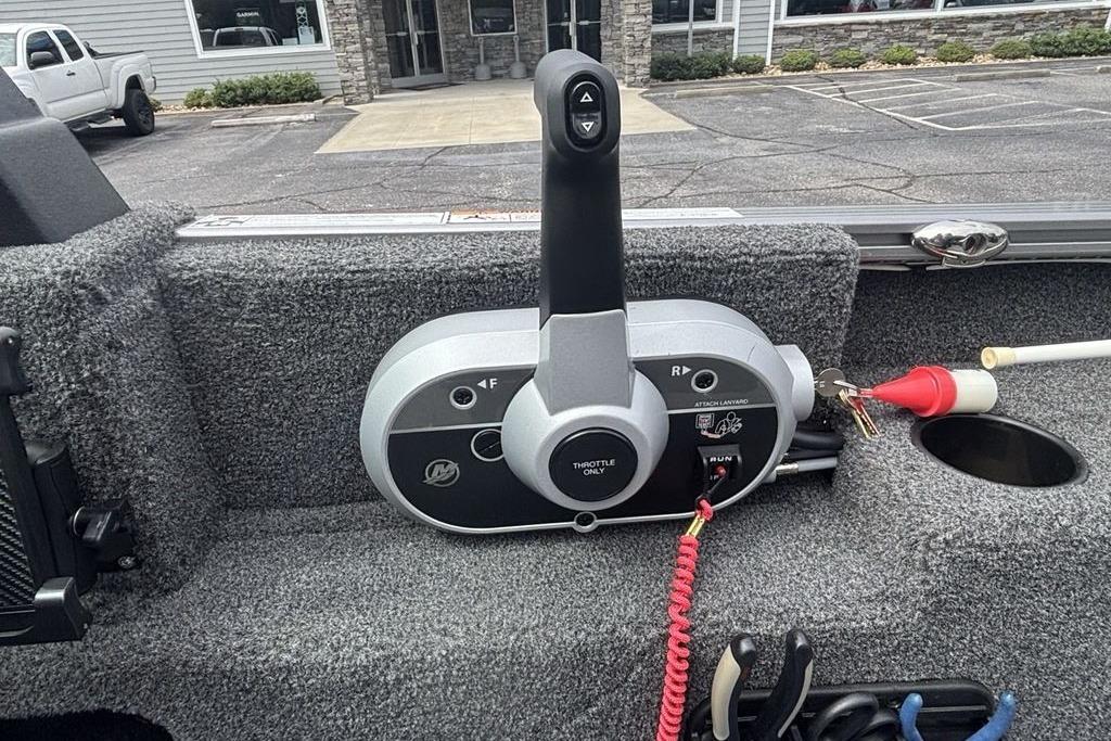 Control panel of a 2021 Lund 1675 Adventure Sport boat, featuring throttle and gear controls.