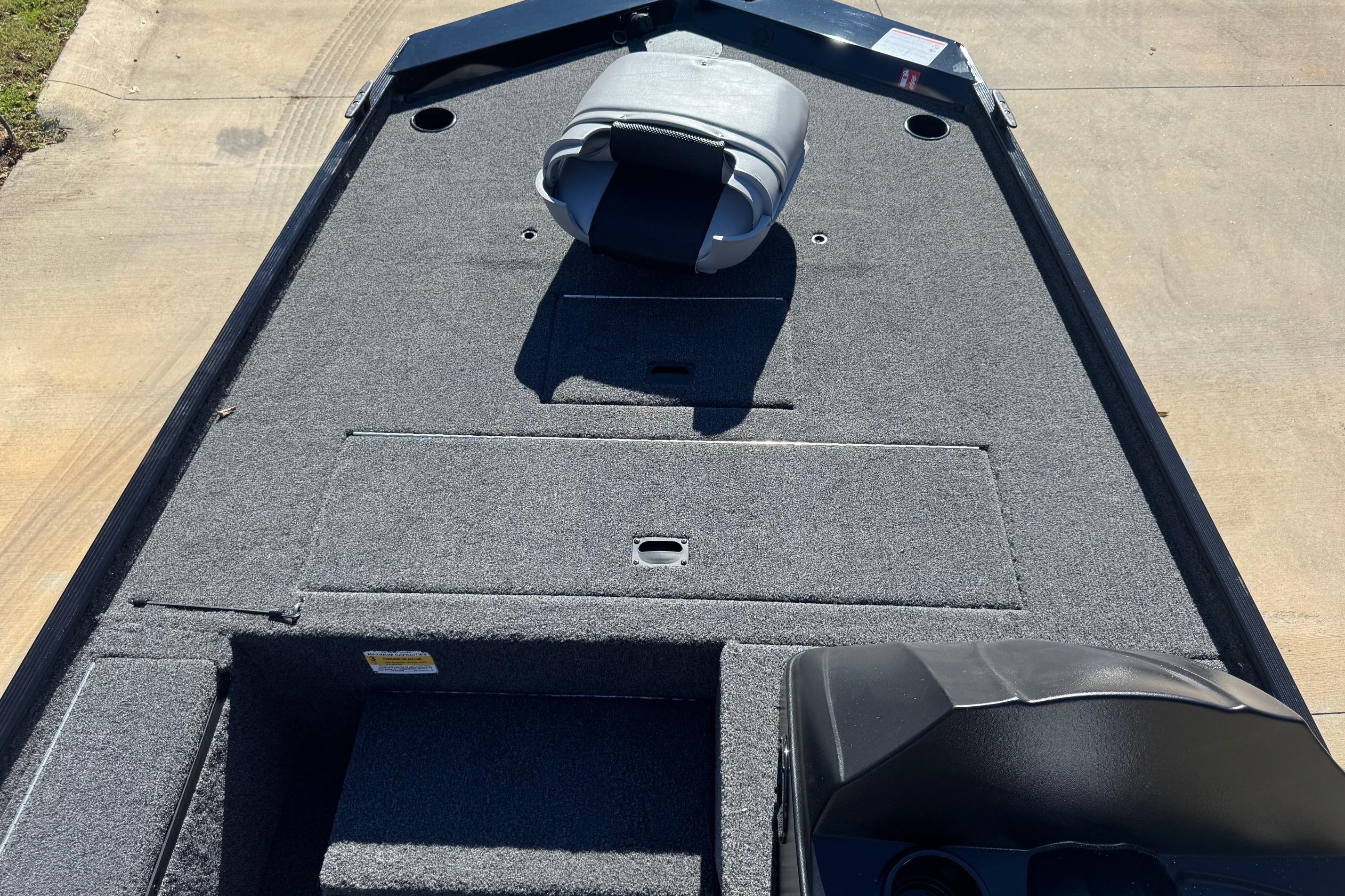 2026 Crestliner 1600 Storm boat interior with carpeted deck and seating.