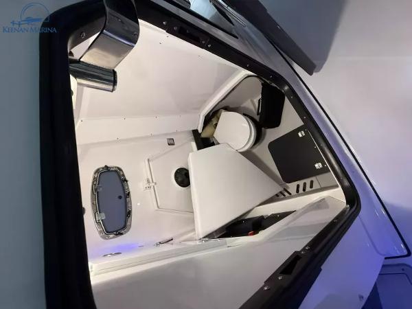 Interior of 2025 Blackfin 272CC boat featuring a compact cabin with a toilet.