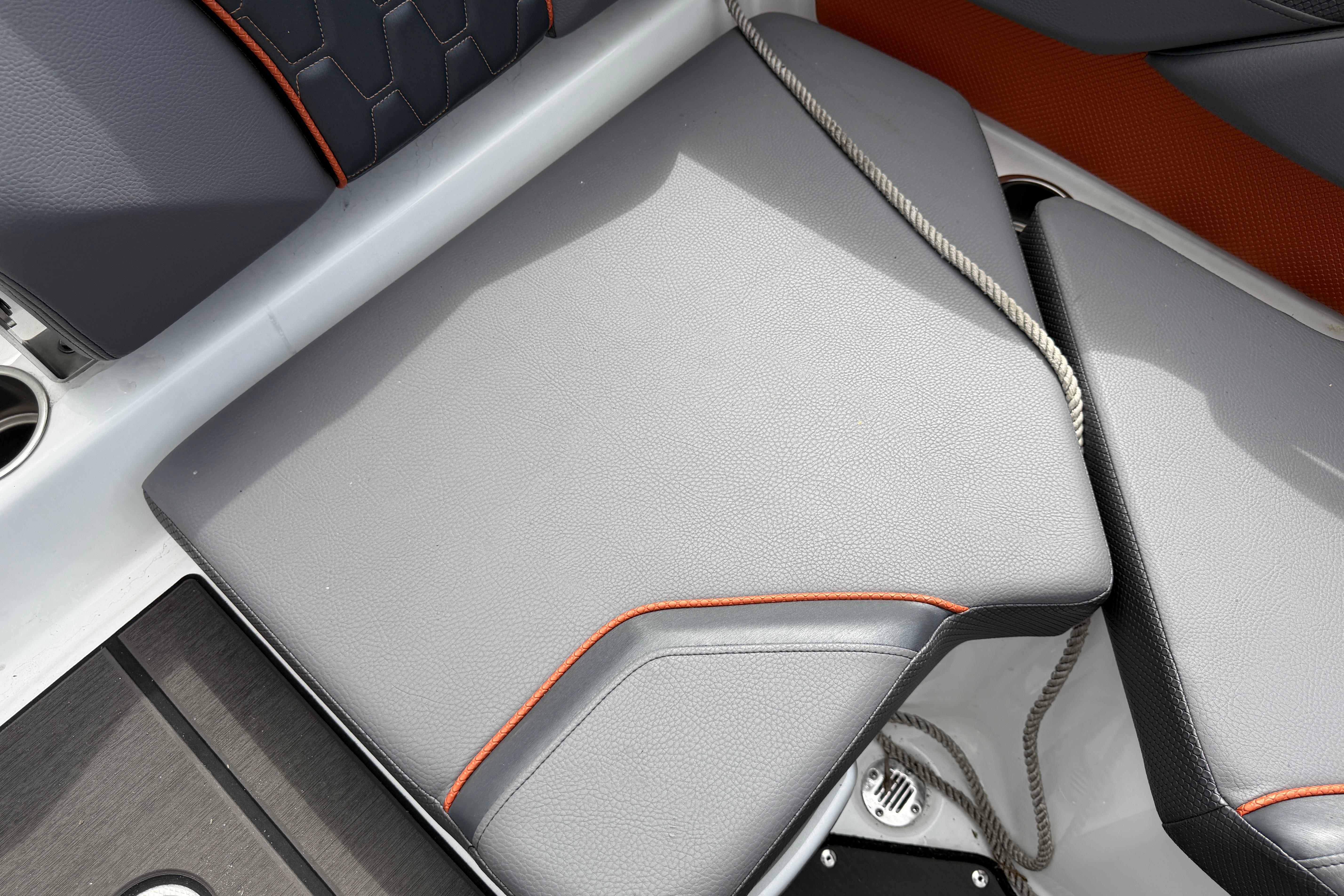 2026 Scarab 235 LX boat interior with gray and orange cushioned seating.