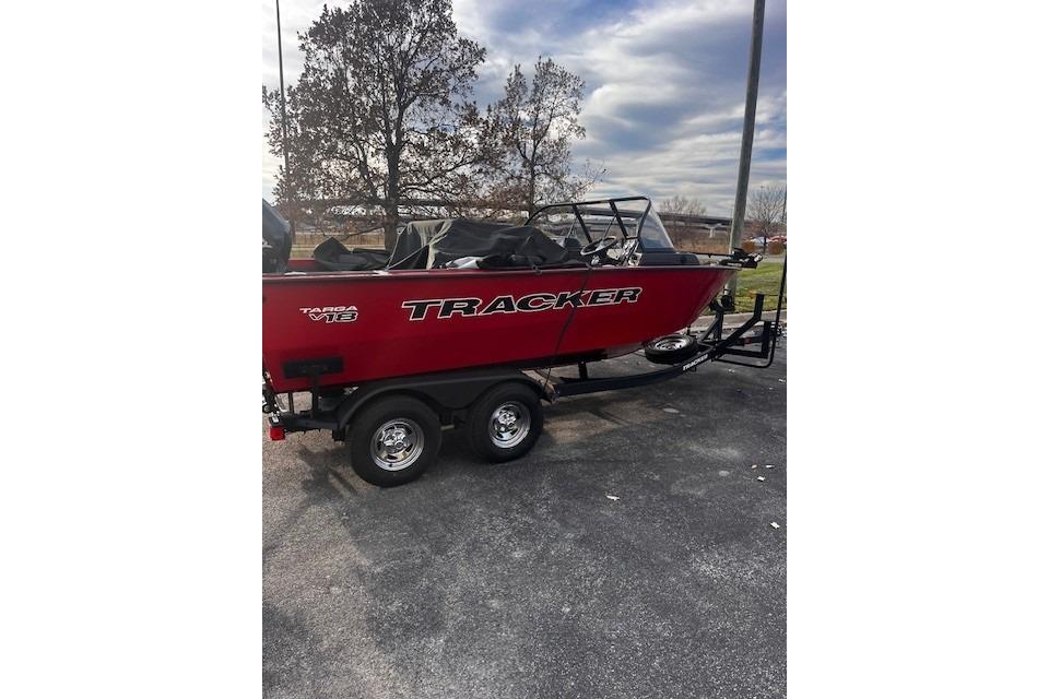 2026 Tracker Targa V-18 WT boat on trailer, parked outdoors under cloudy sky.
