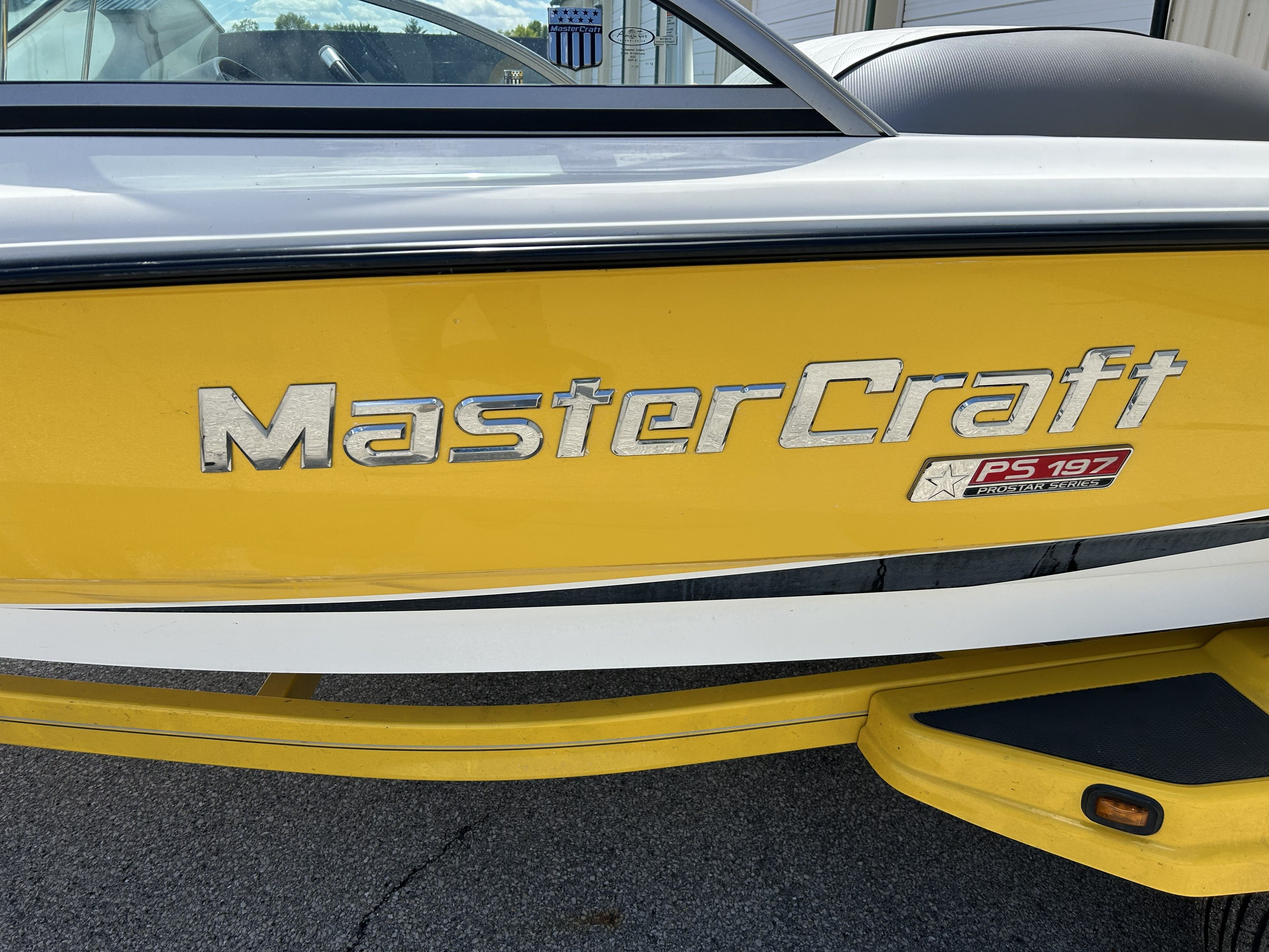 Yellow 2011 MasterCraft PS197 boat, close-up of logo.