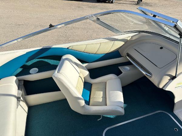 Interior of a 1995 Larson 174 SEI boat with white and blue seating.