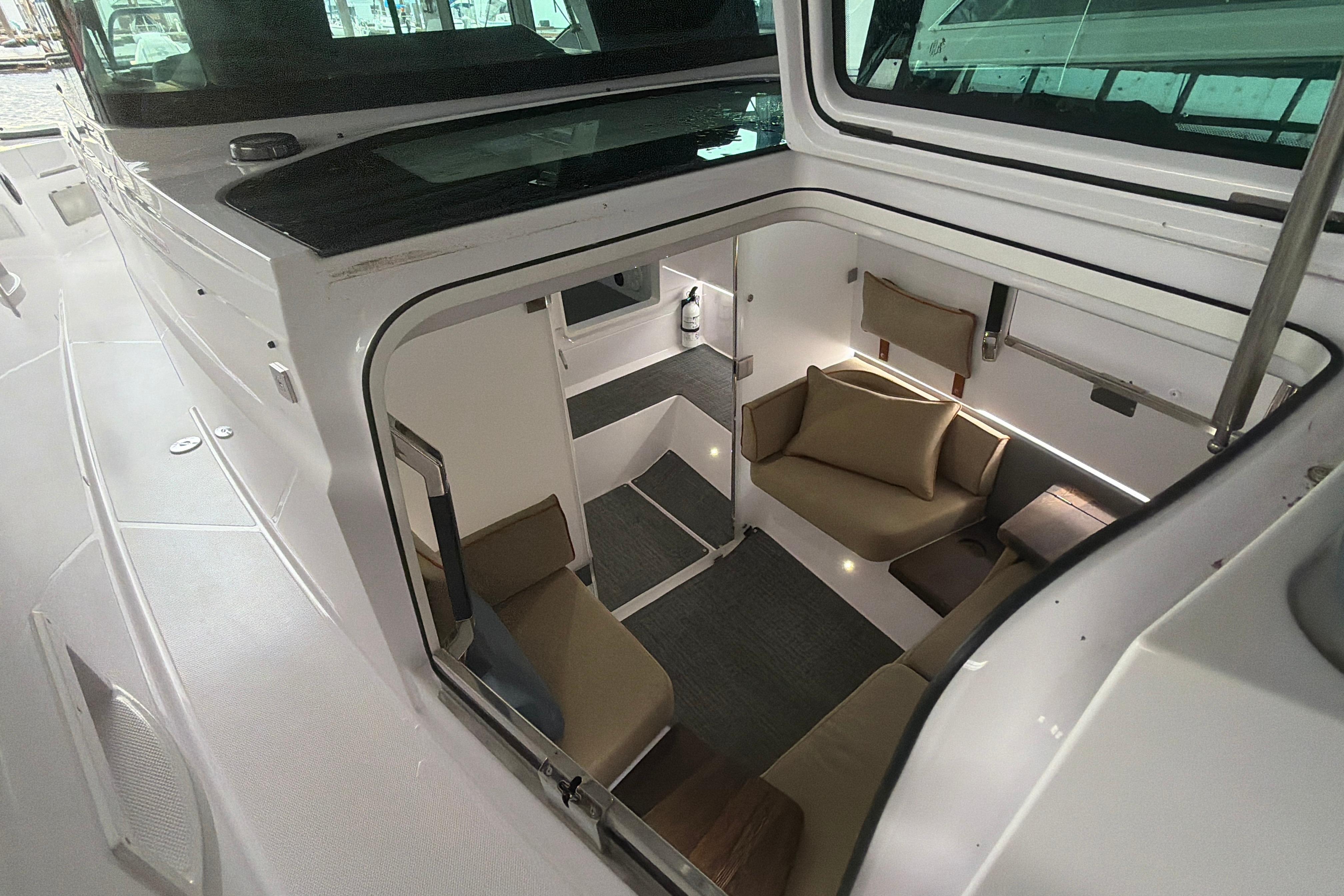 Interior view of 2022 Axopar Brabus 37 XC Cross Cabin, featuring cozy seating and modern design.