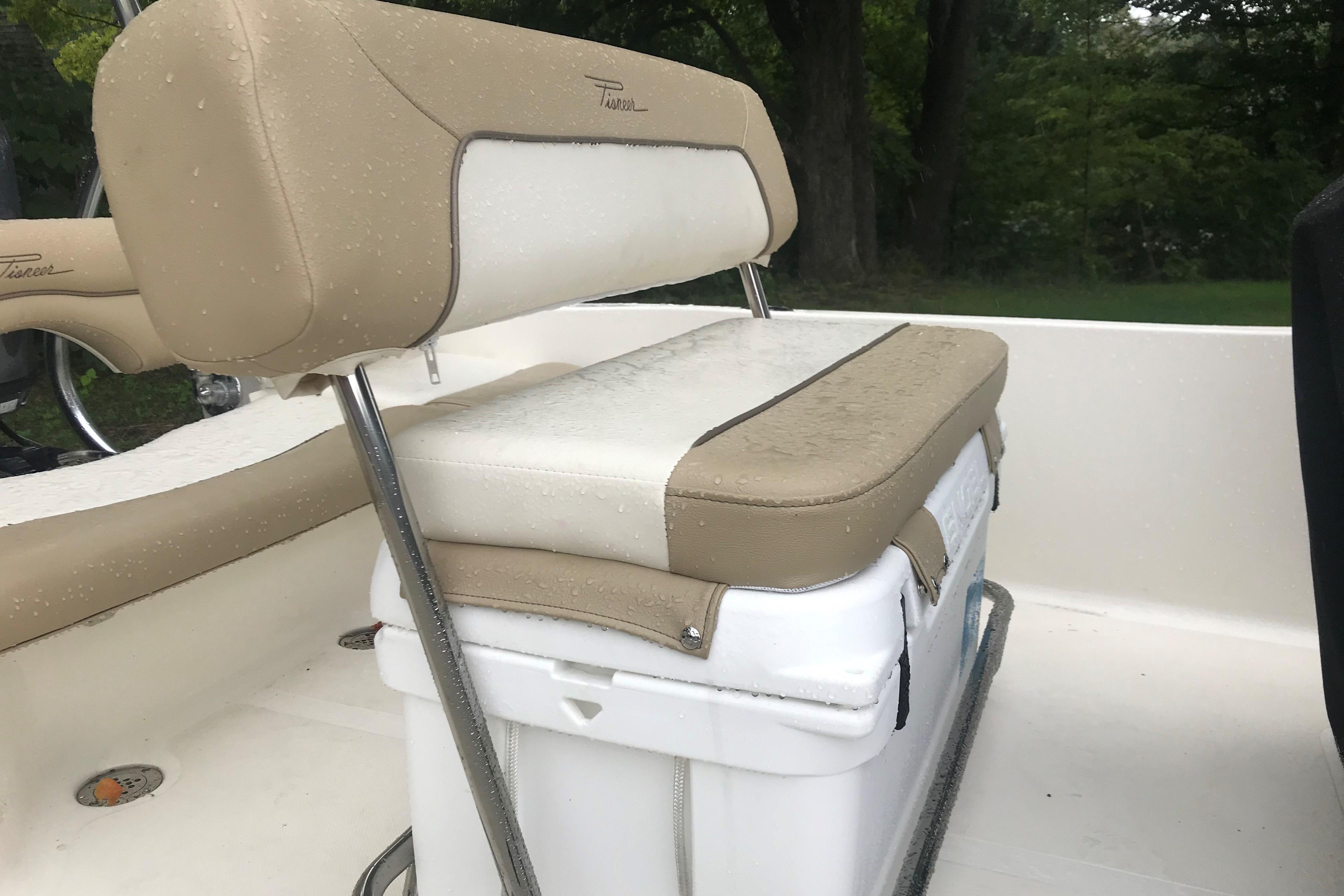 2026 Pioneer 180 Islander boat seat with beige and white upholstery, featuring a cooler underneath.