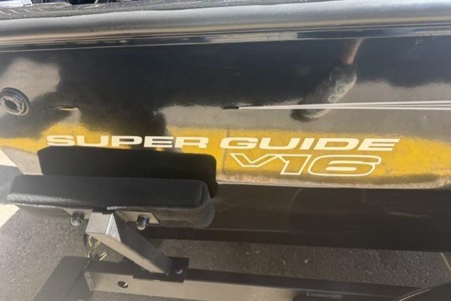 2026 Tracker Super Guide V-16 SC boat, black exterior with yellow lettering.