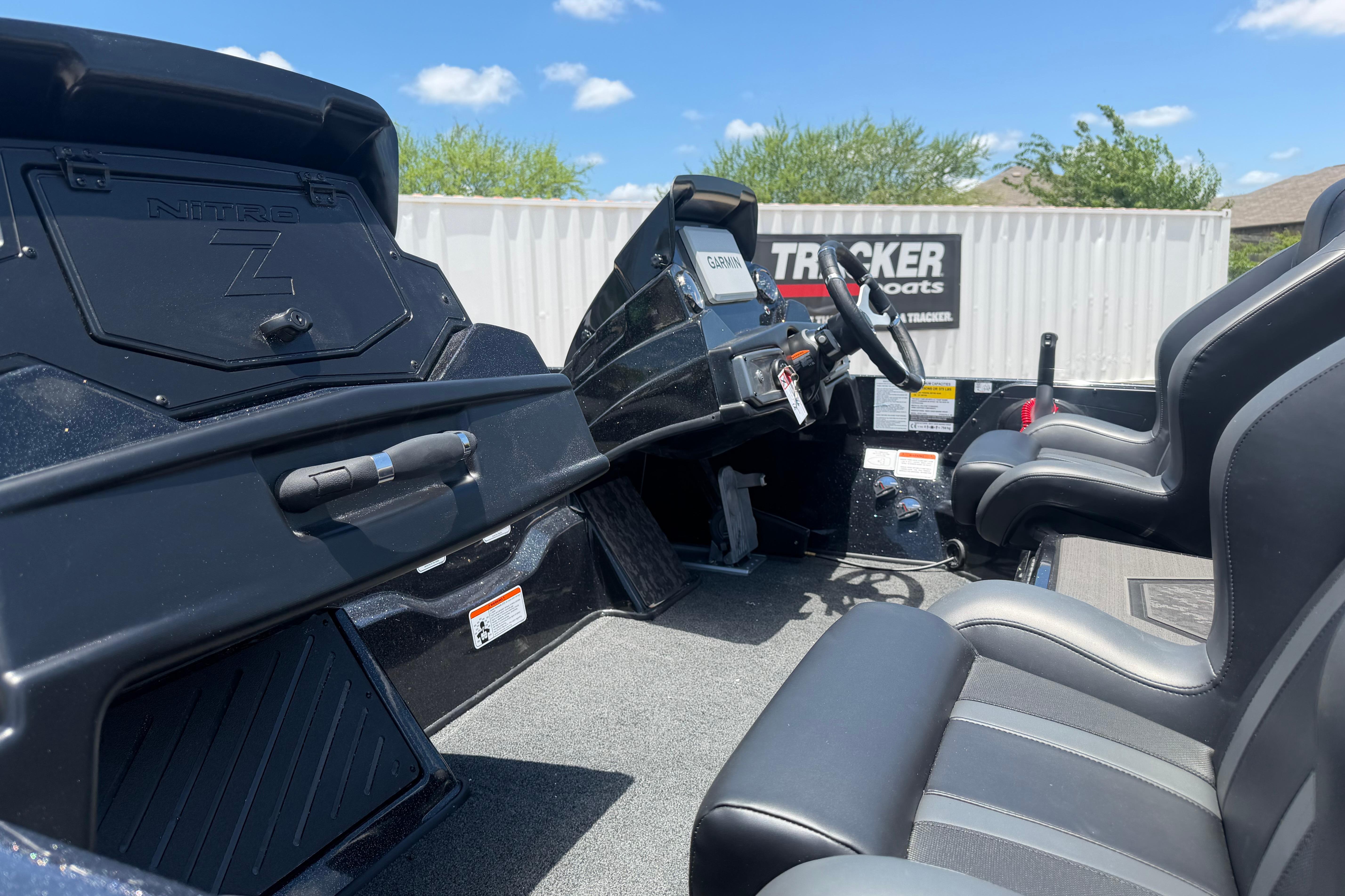 2026 Nitro Z20 XL Pro boat interior with steering wheel and seats under blue sky.