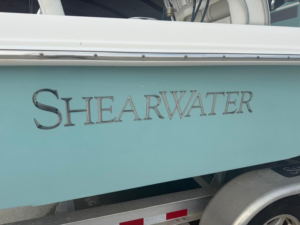 2017 ShearWater 270 Carolina Flare boat with logo on light blue hull.