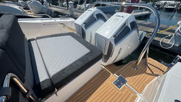 Luxury Nimbus T11 boat with dual Mercury outboard engines, 2025 model, docked at marina.
