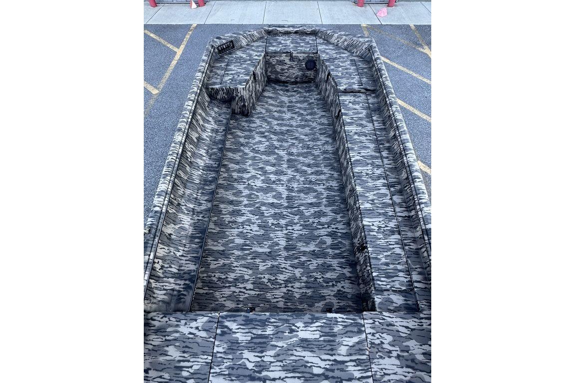 2026 Havoc 1756 boat with camouflage interior design, parked on pavement.