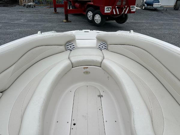 2004 Starcraft Aurora 2410 boat interior with white seating and speakers.