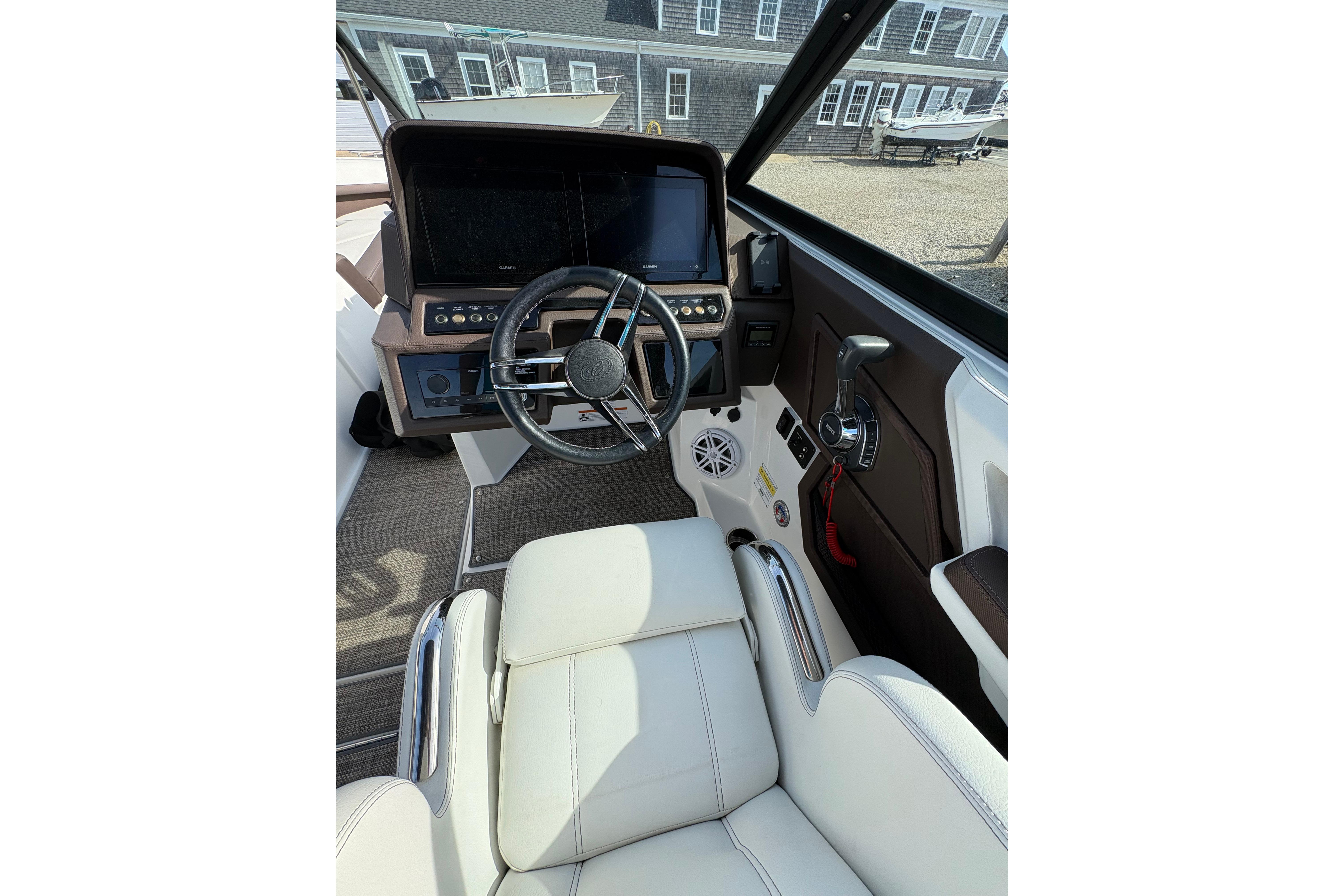 Interior view of 2022 Cobalt R6 boat cockpit with steering wheel and controls.