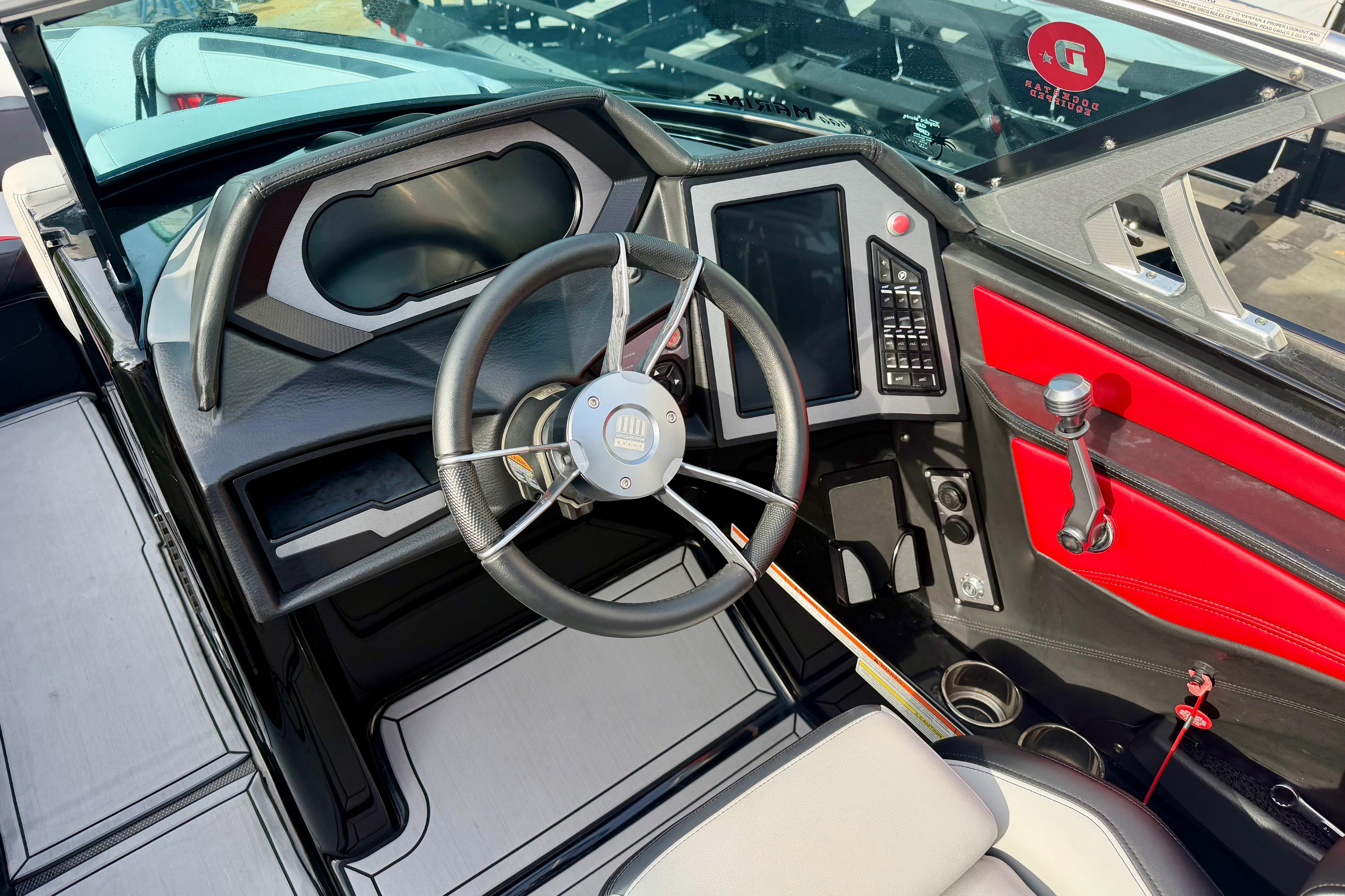 2019 MasterCraft XStar boat cockpit with steering wheel and control panel.