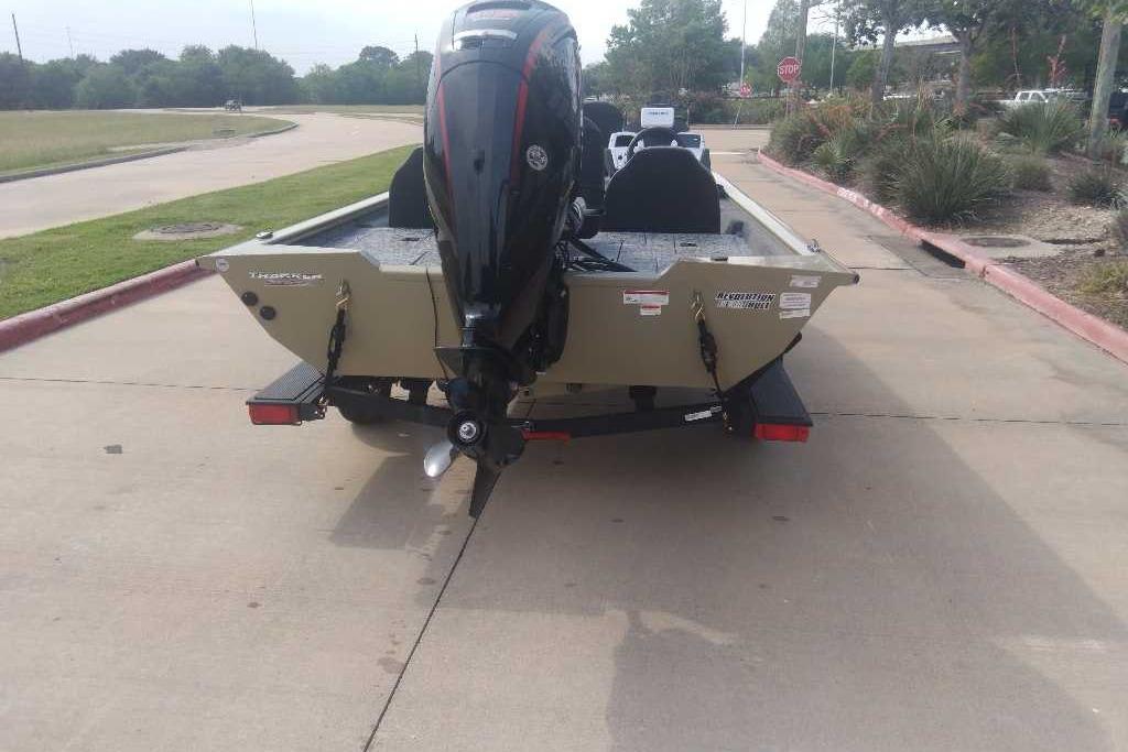 2026 Tracker Pro Team 190 boat on trailer, rear view, parked on concrete.