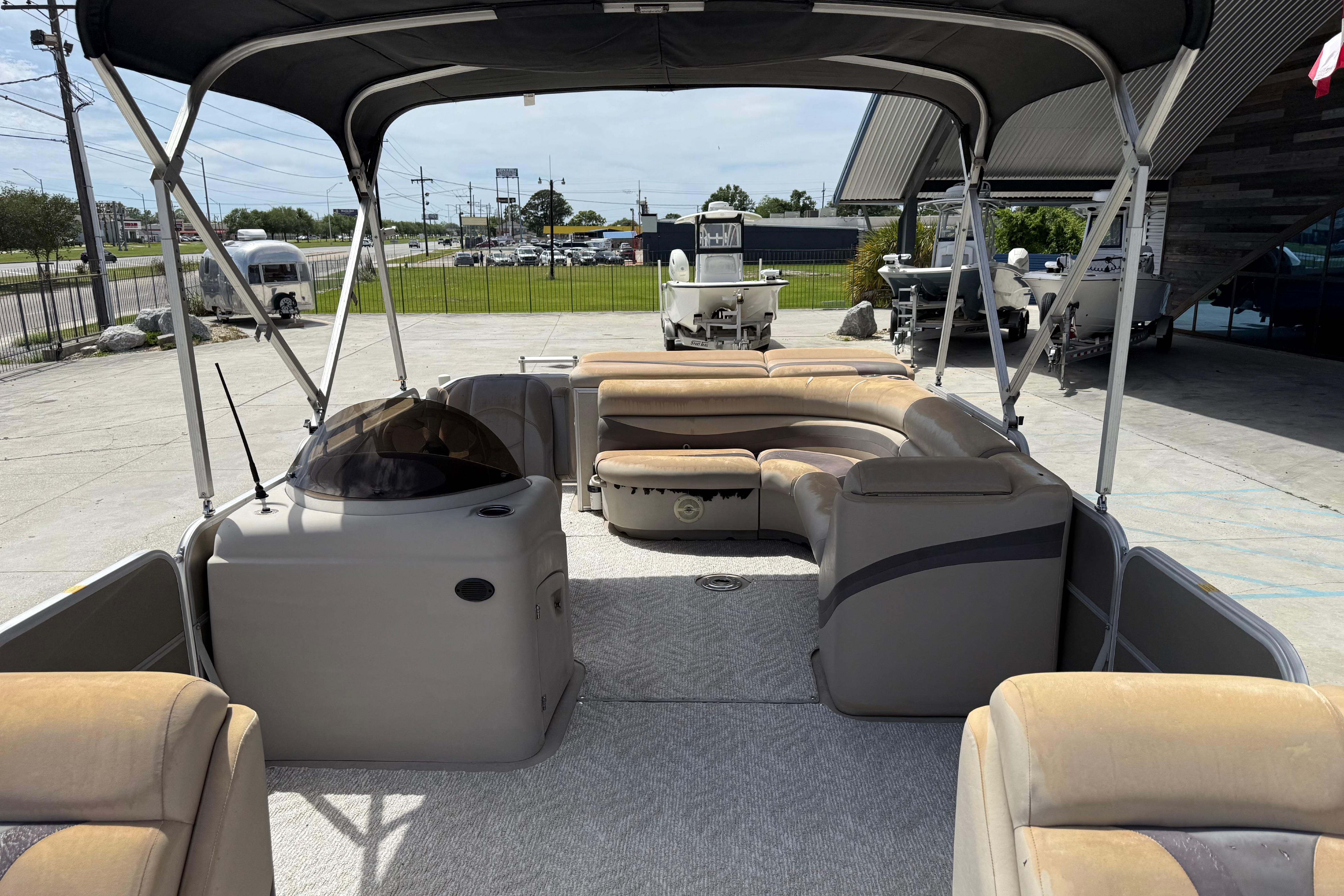 2012 South Bay 522 CR pontoon boat with spacious seating and canopy in a marina setting.