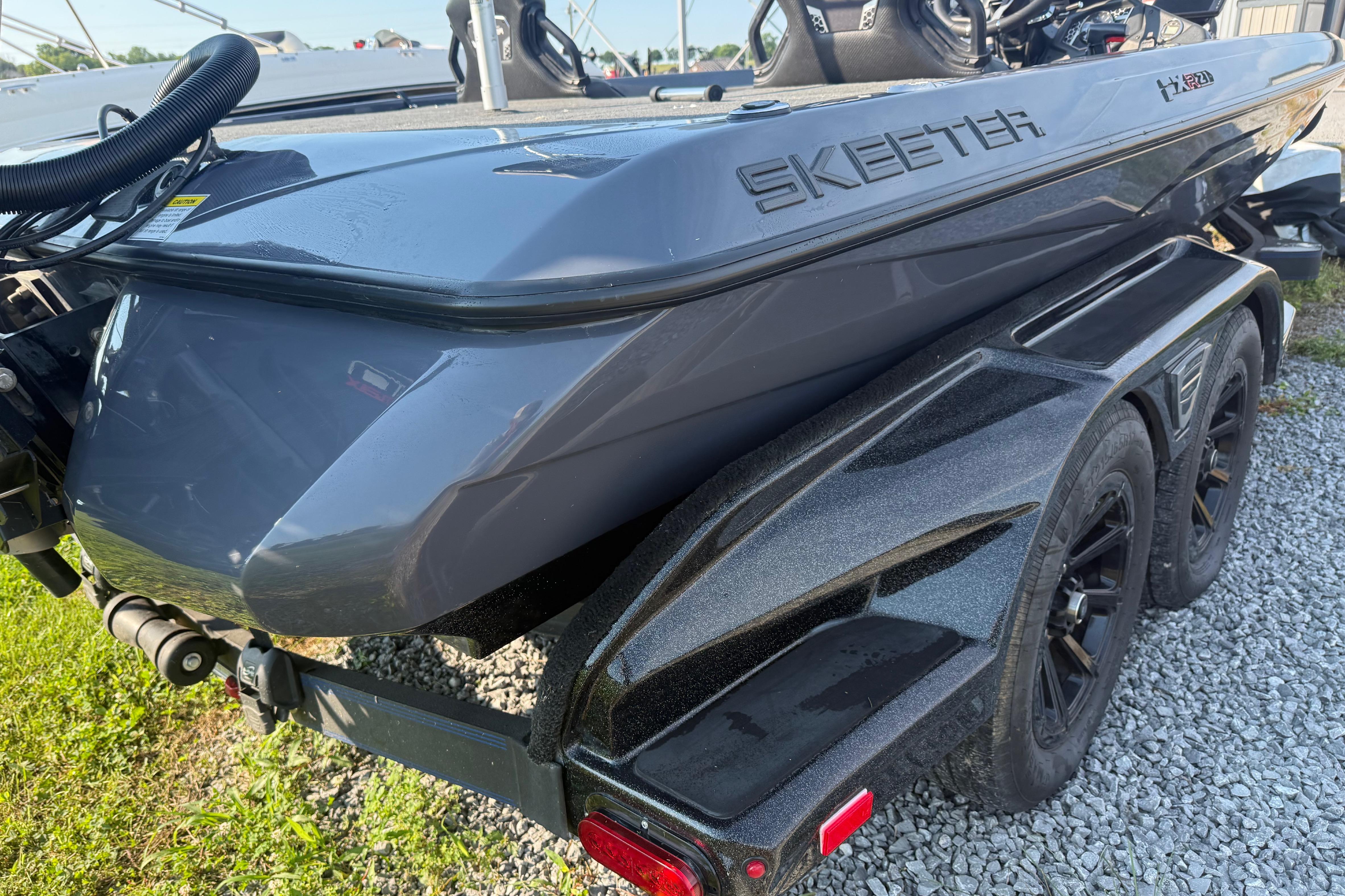 2024 Skeeter FXR21 boat on trailer, showcasing sleek design and dual axles.