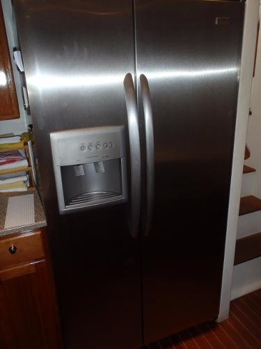 Stainless steel refrigerator with ice dispenser in a Great Harbour N40 yacht kitchen, 2025 model.
