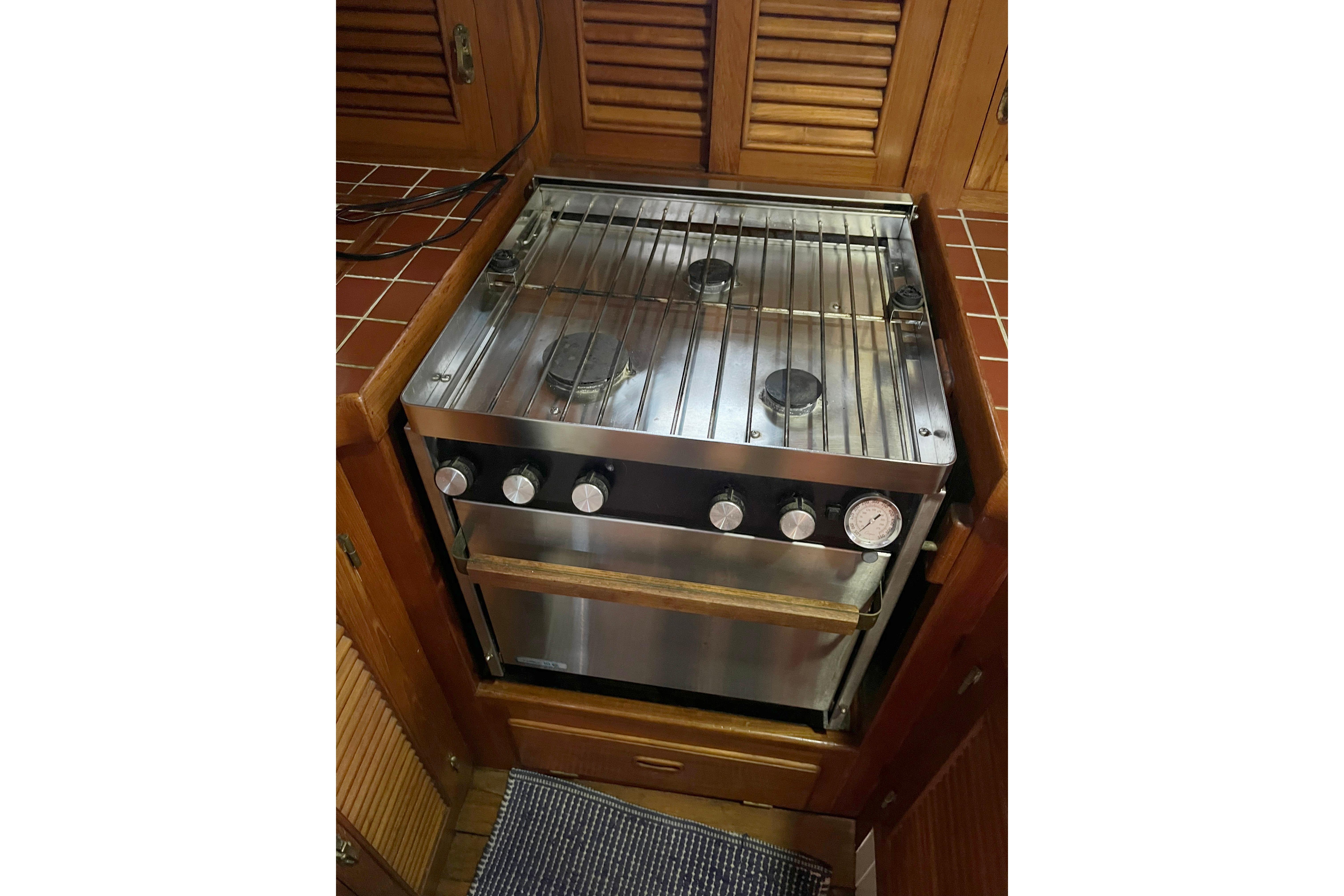1987 Liberty Gatsby stove with stainless steel finish in a wooden kitchen setting.