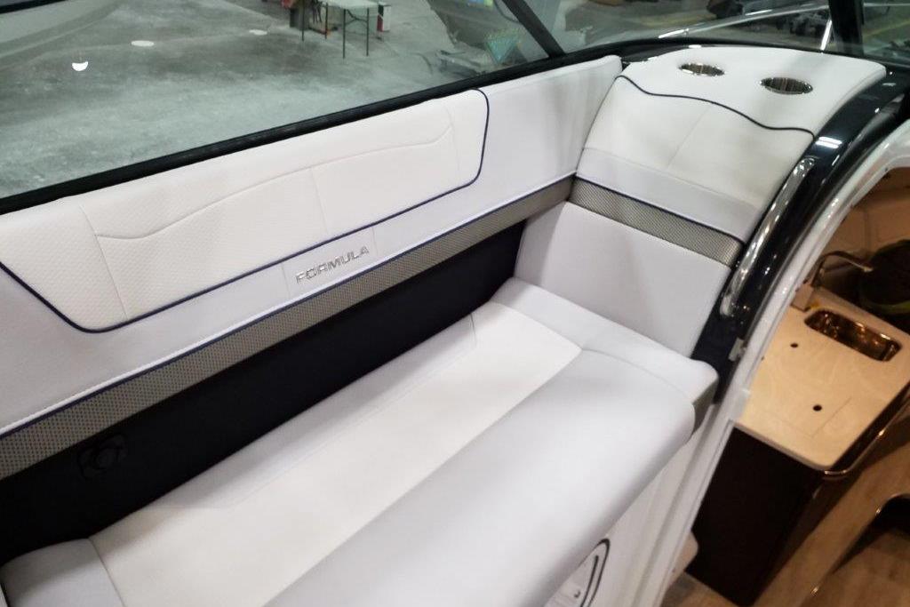 2021 Formula 350 Sun Sport boat interior with white seating and cup holders.