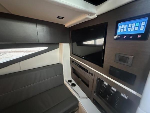 Interior of 2022 Cobalt A36BR boat with modern seating, TV, and control panel.