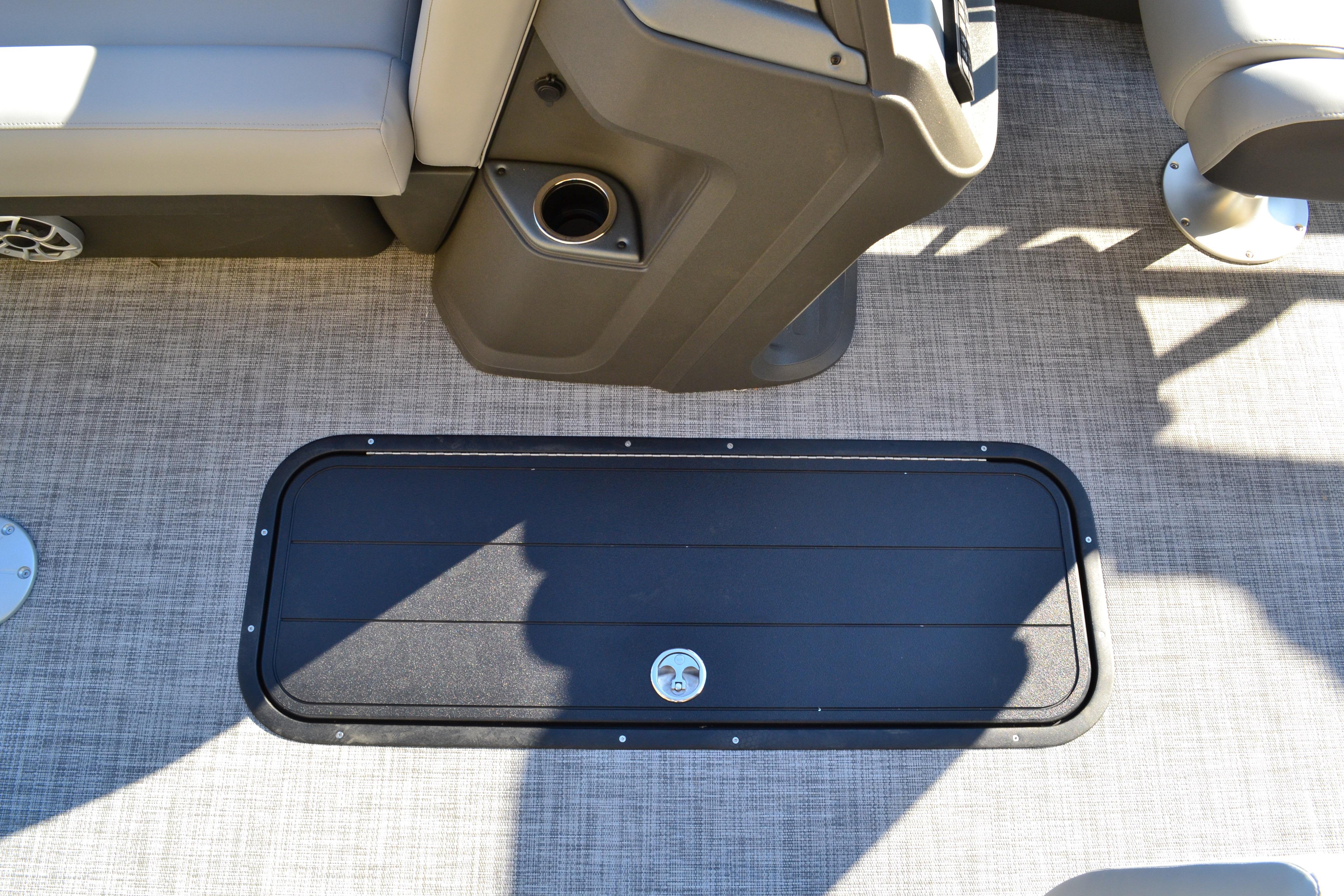 2026 Sun Tracker SportFish 22 XP3 boat interior with storage compartment and cup holder.