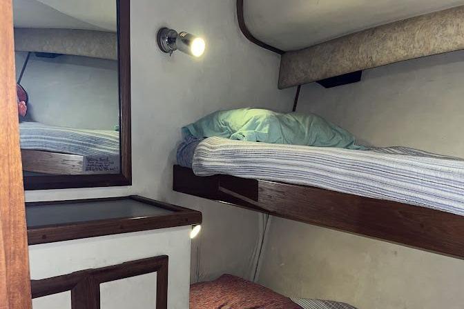 Interior cabin of 1989 Topaz 44 Sportfisherman with bunk beds and wall light.