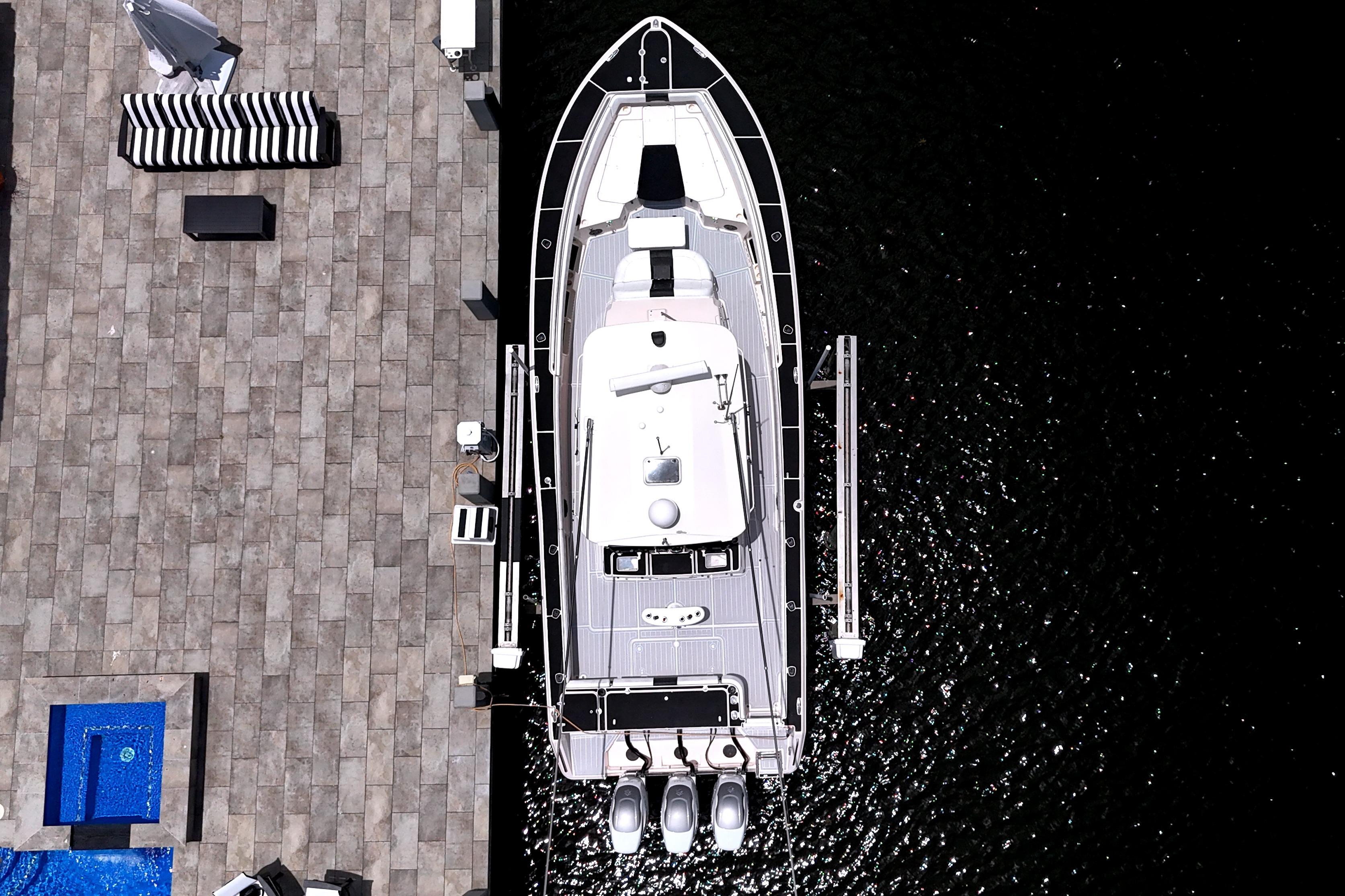 Overhead view of 2010 Grady-White Canyon 366 docked beside a stone patio.