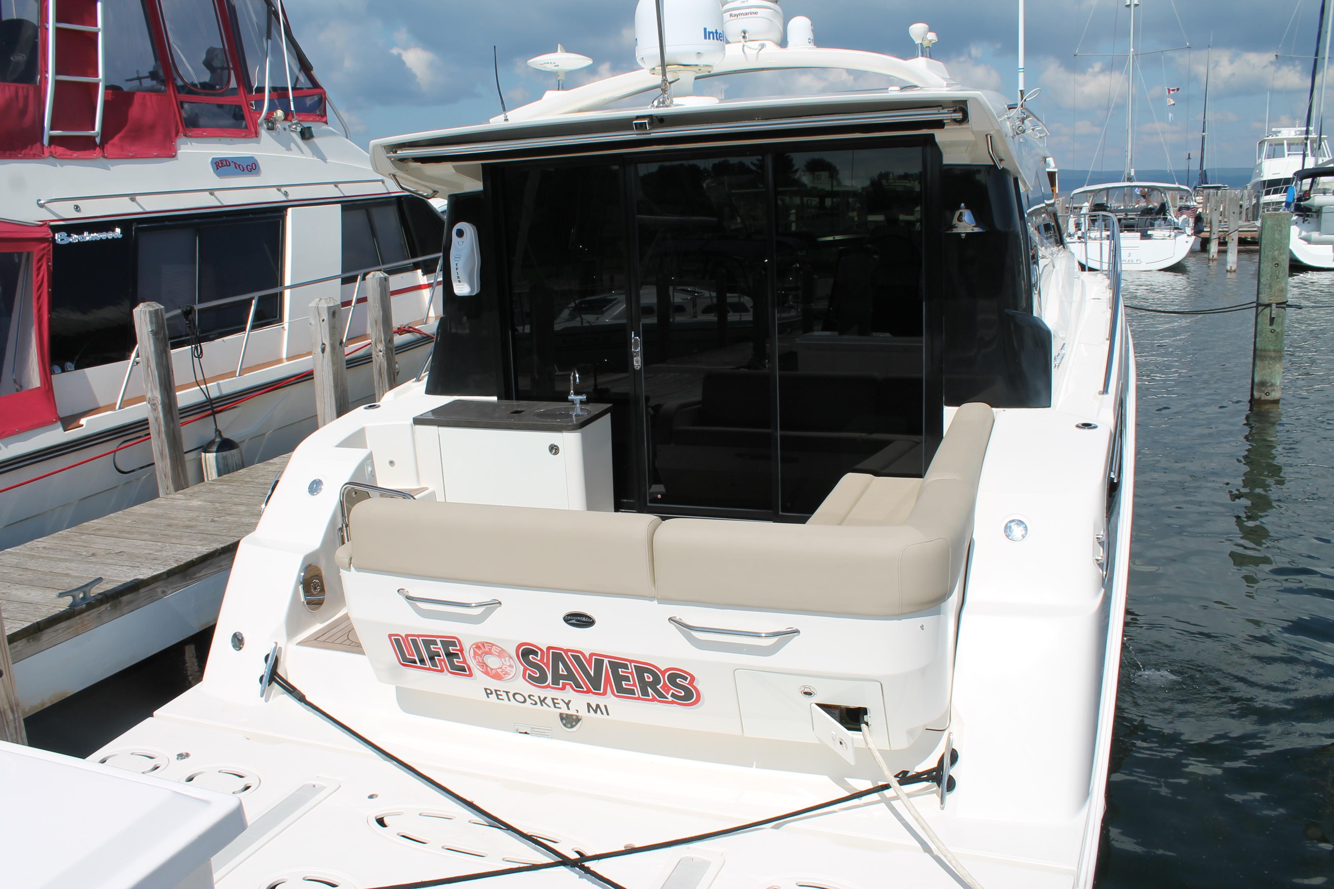2015 Sea Ray 470 Sundancer yacht docked at marina, rear view.