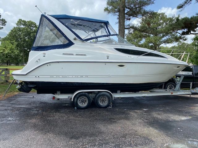 2002 Bayliner 2855 on trailer parked outdoors.