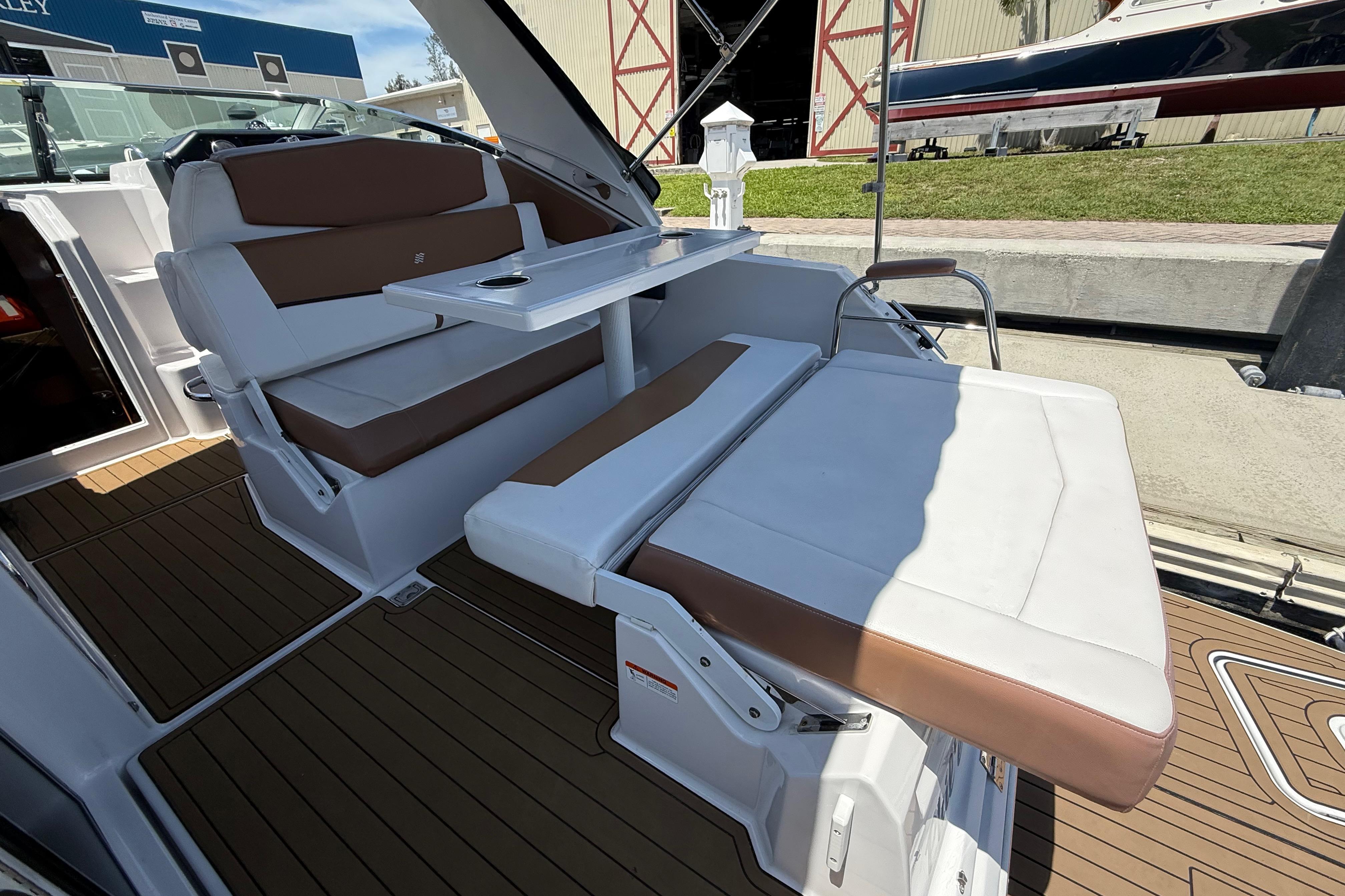2017 Four Winns V275 boat interior with brown and white seating and table.