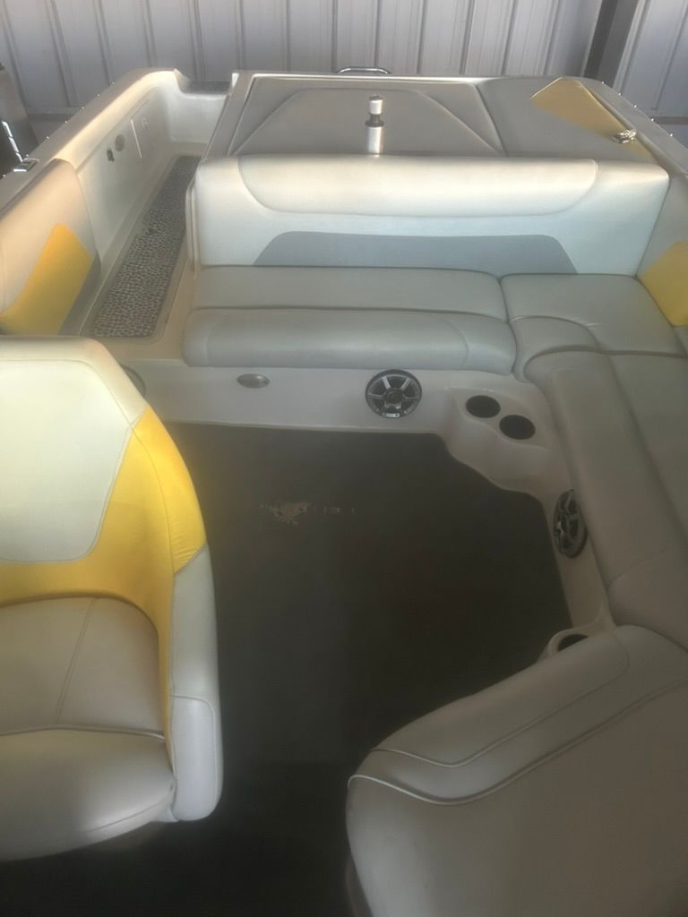 Interior of a 2003 Centurion Avalanche boat with yellow and gray seating.