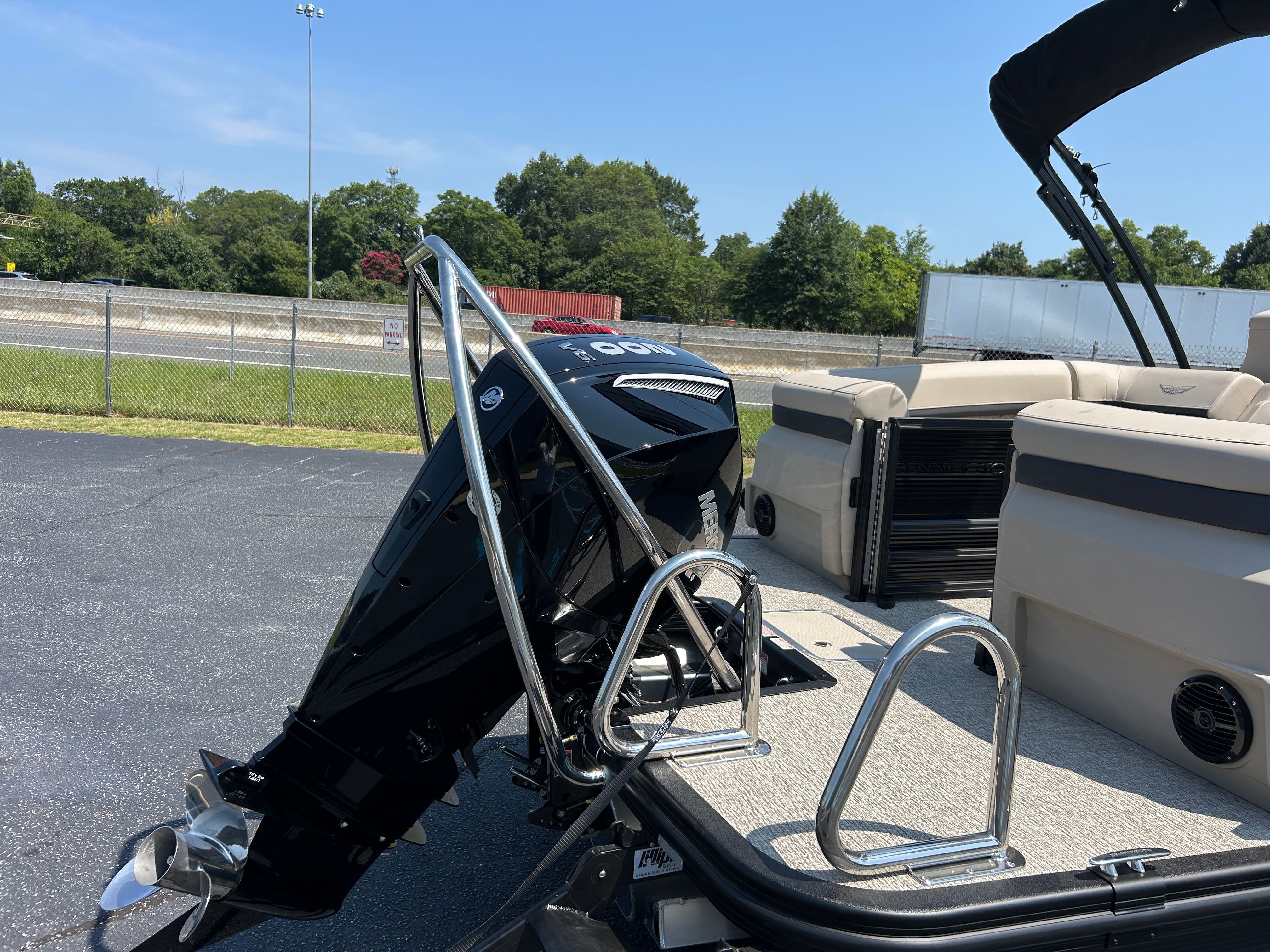 A 2026 Bennington 22 MFB with an outboard motor, parked on a lot.