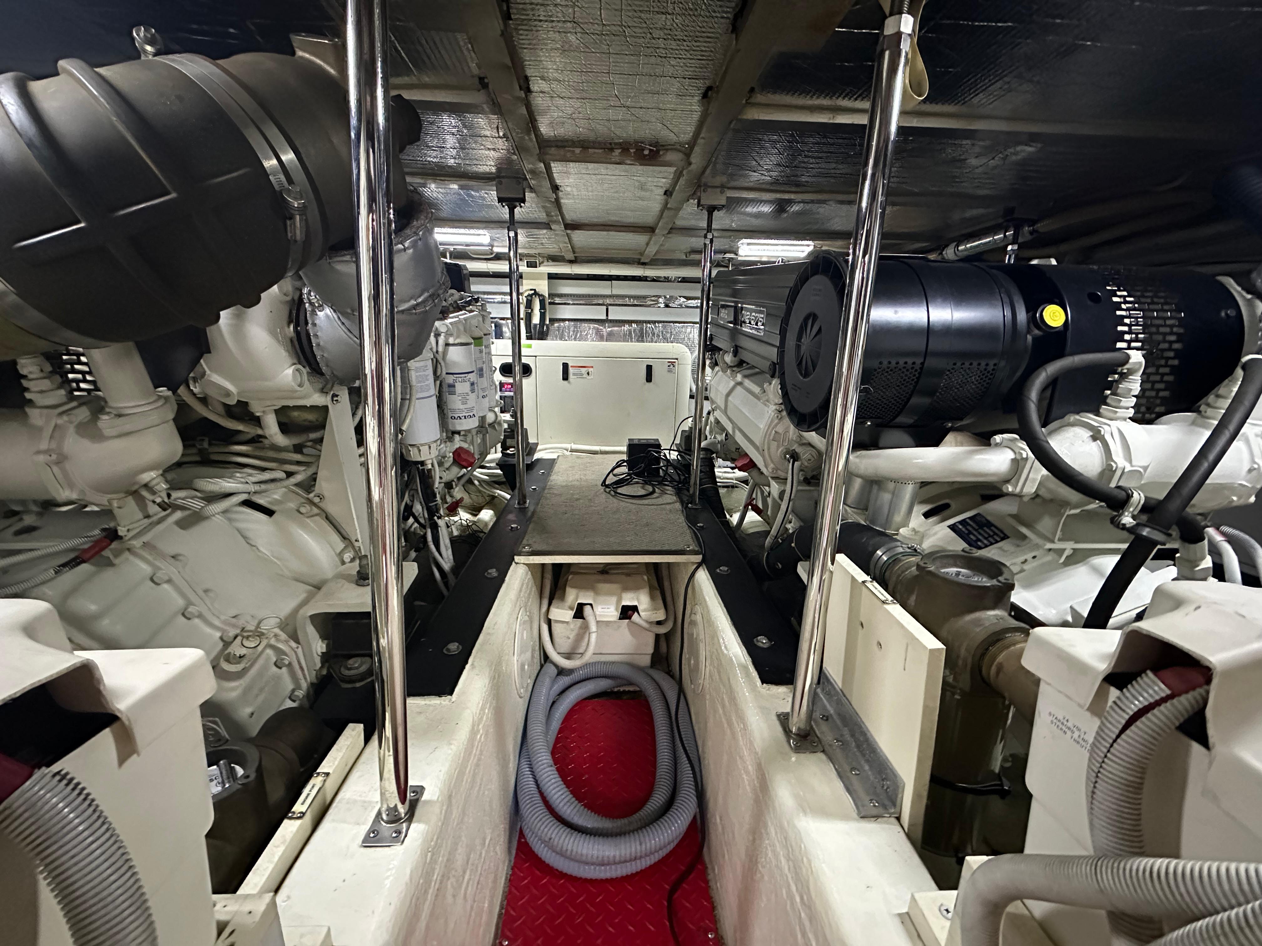 Engine room of 2005 Carver 56 Voyager yacht, showcasing mechanical components and equipment.