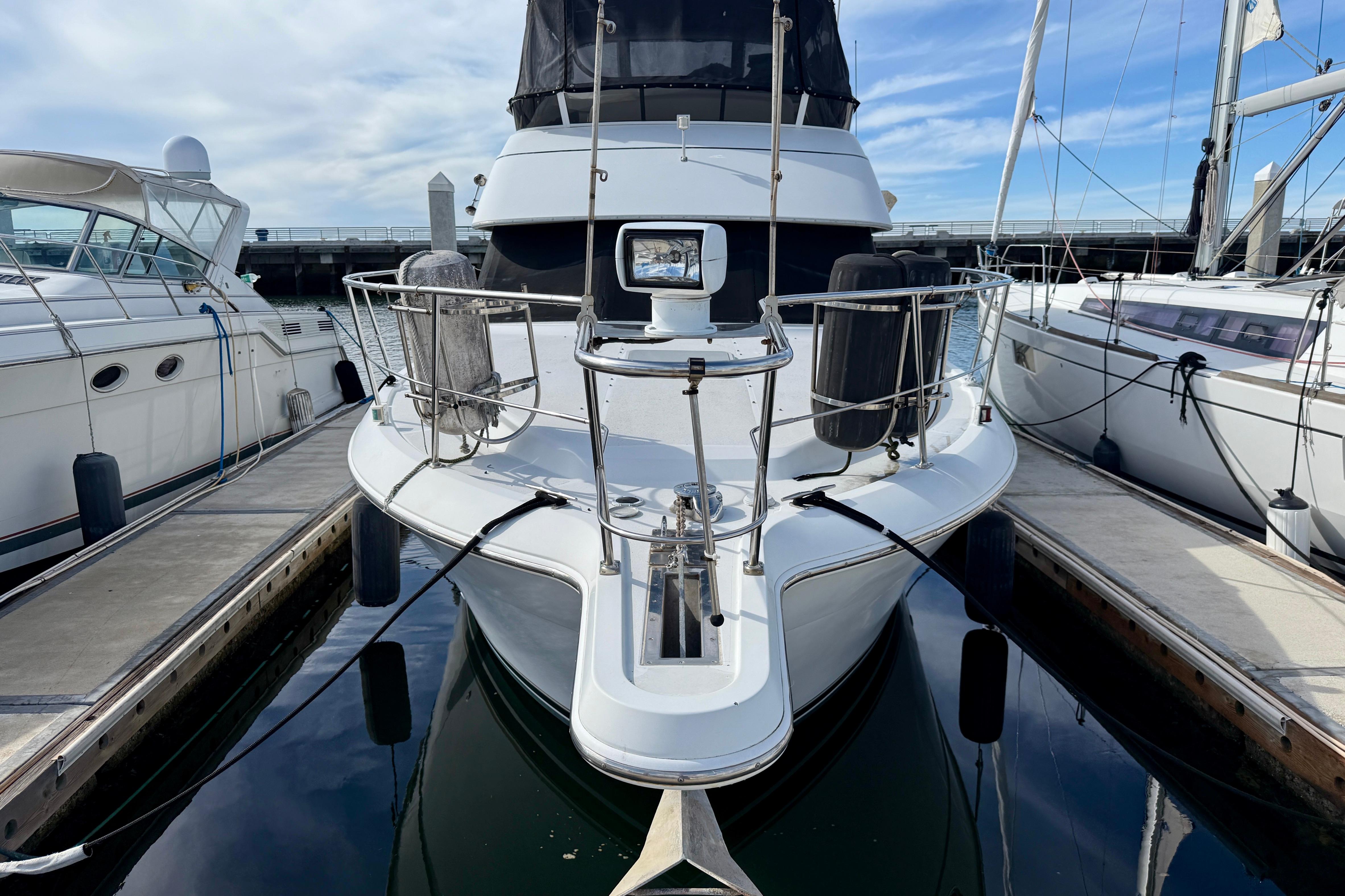 1997 Carver 355 Aft Cabin Motor Yacht docked at marina, front view.