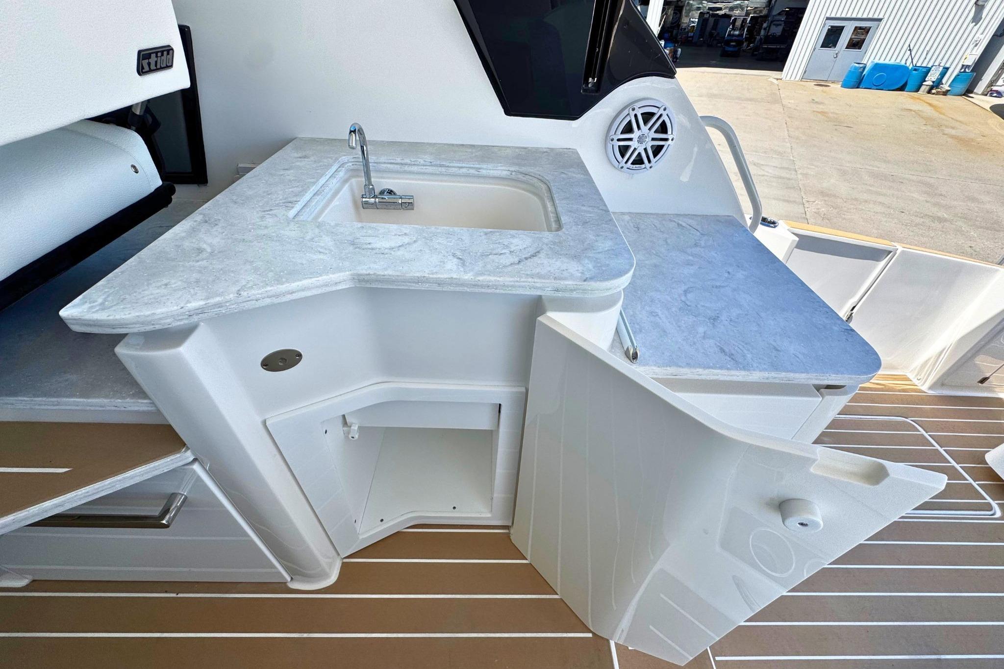 2027 Tiara Yachts 39 LE boat kitchenette with sink and storage.
