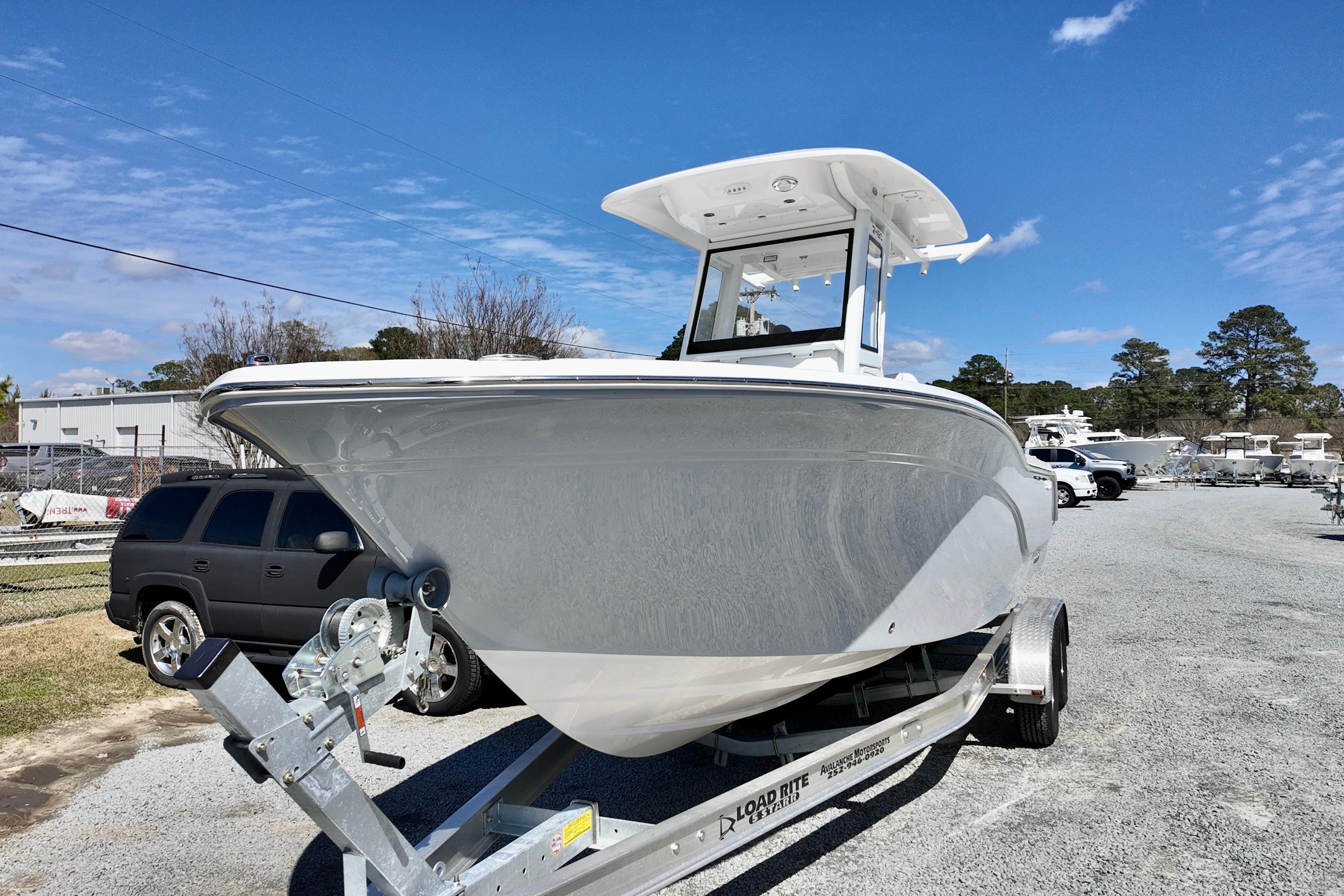2026 Sea Fox 248 Commander boat on trailer under clear blue sky.
