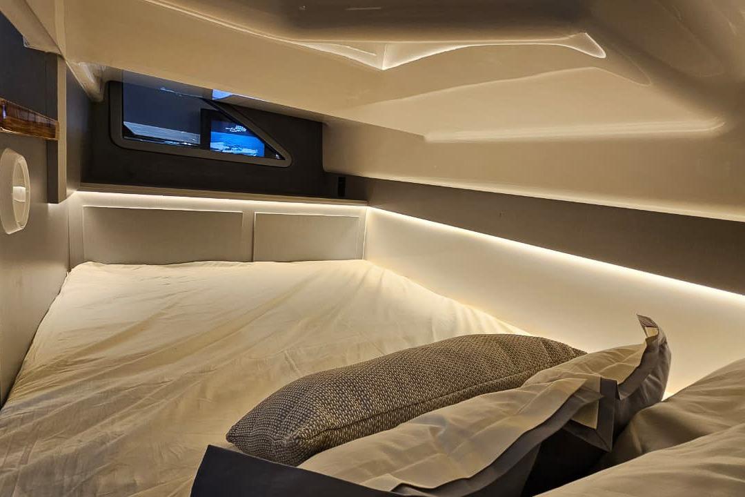 Luxurious interior of 2027 Hanover 327, featuring a cozy bed with ambient lighting.
