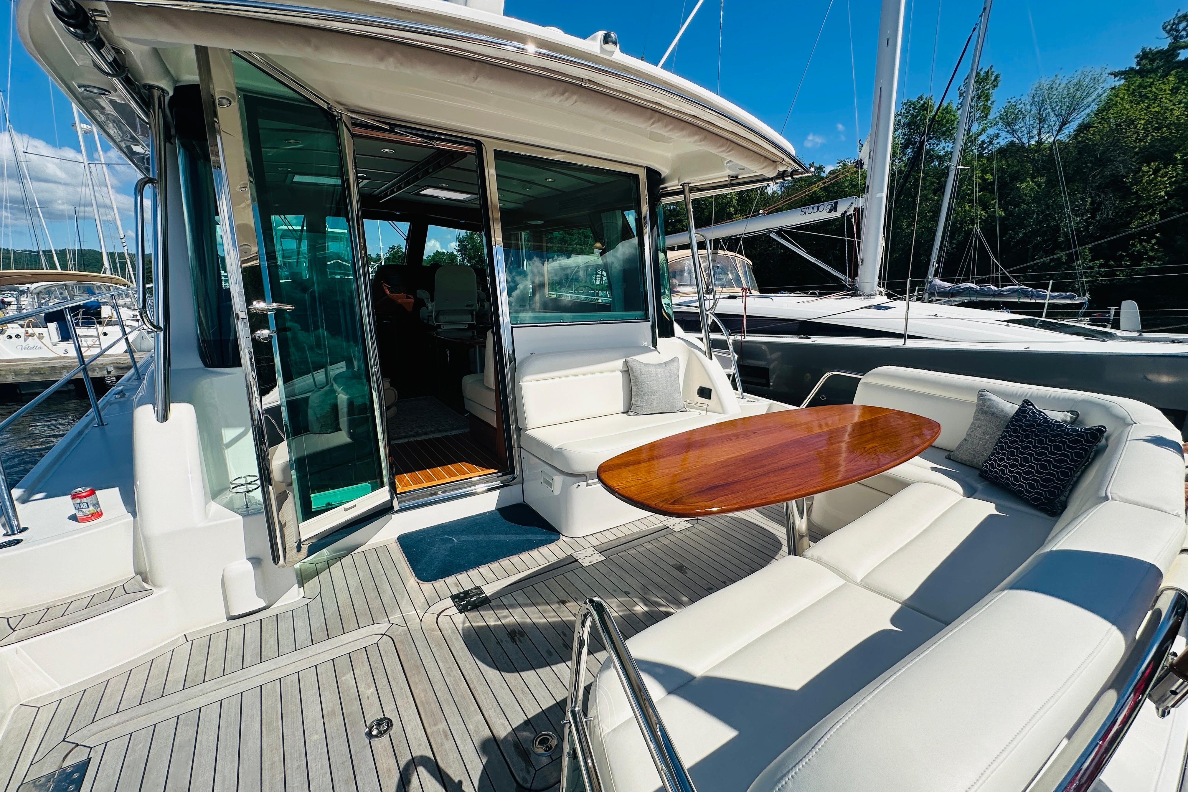2025 Sabre 48 Salon Express yacht with elegant outdoor seating and wooden table.