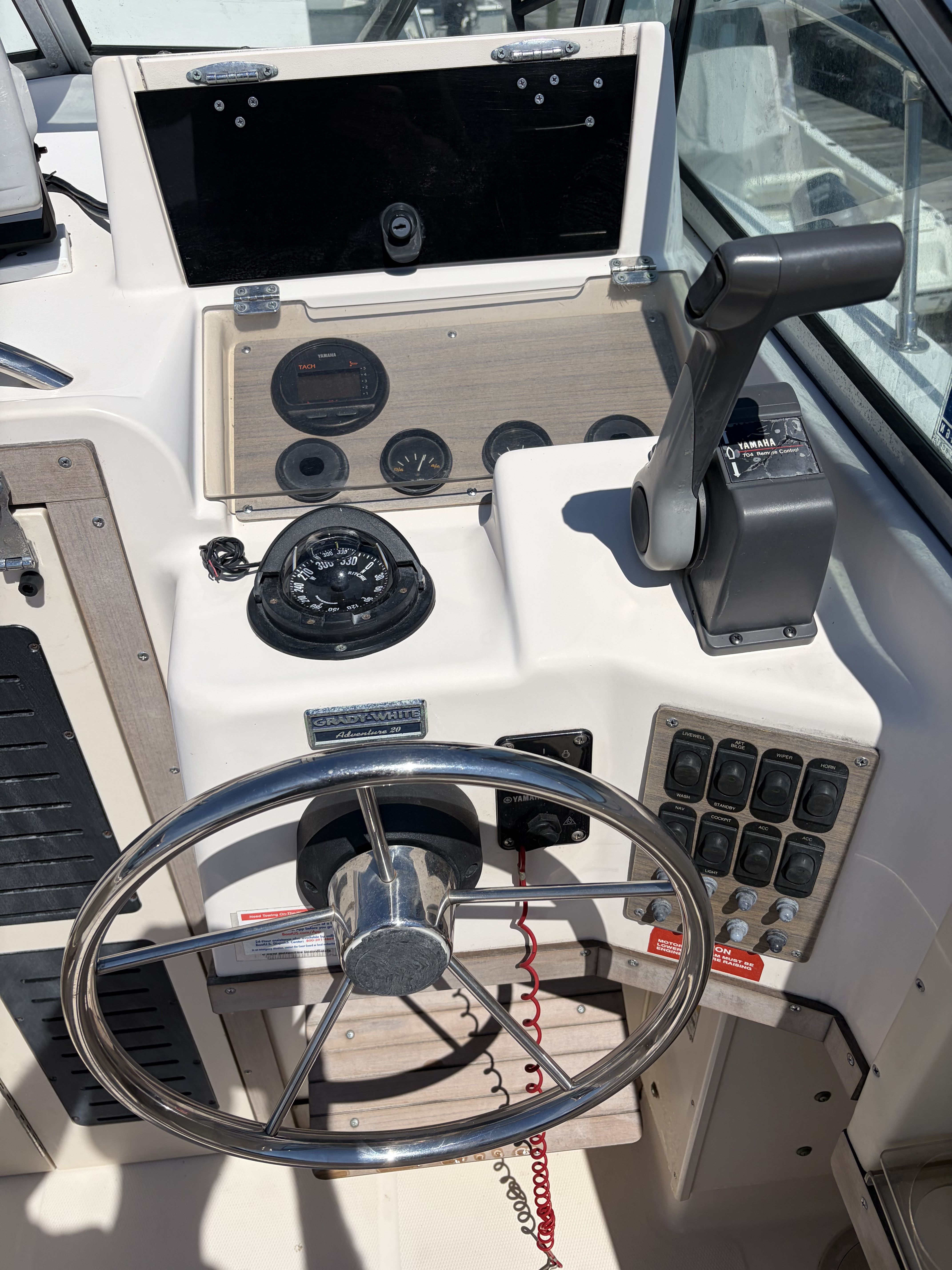 The image shows the helm of a 1993 Grady-White Adventure 208 boat.